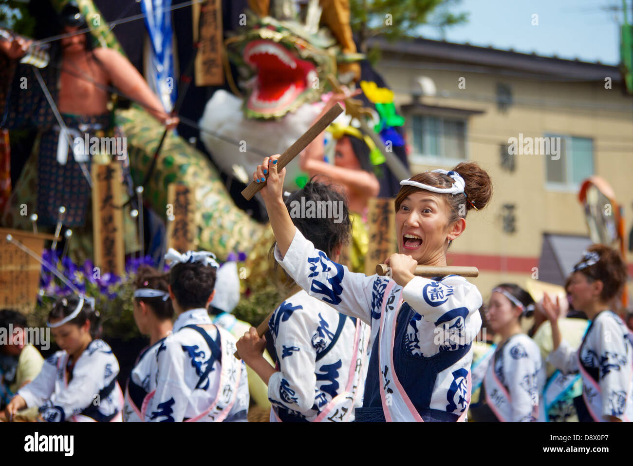 A Japanese lady holding her drum sticks in excitement during the Akita summer festival. She is a participant in the festival. Stock Photo