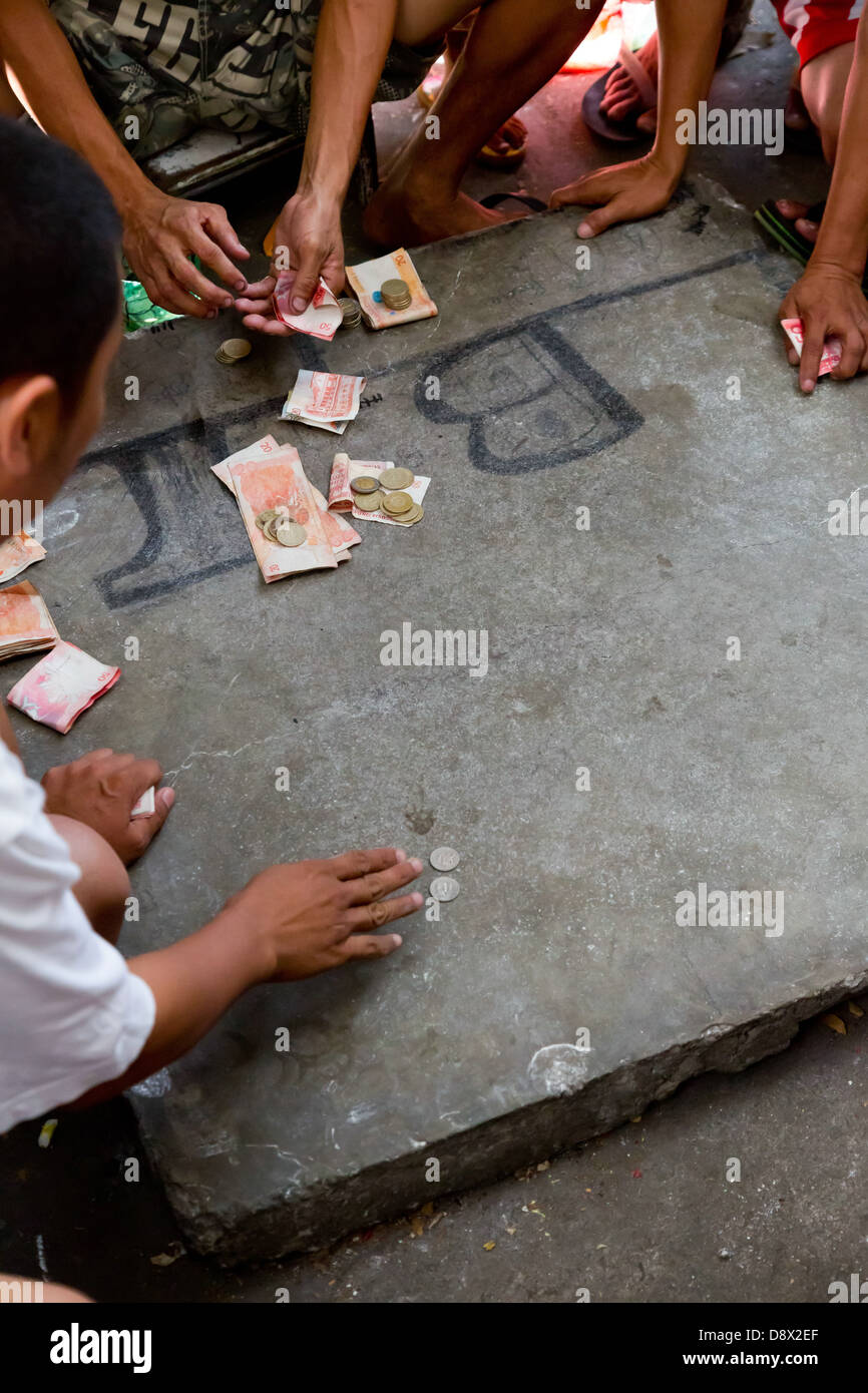 Men gambling in the Streets of the old Town Intramouros in Manila