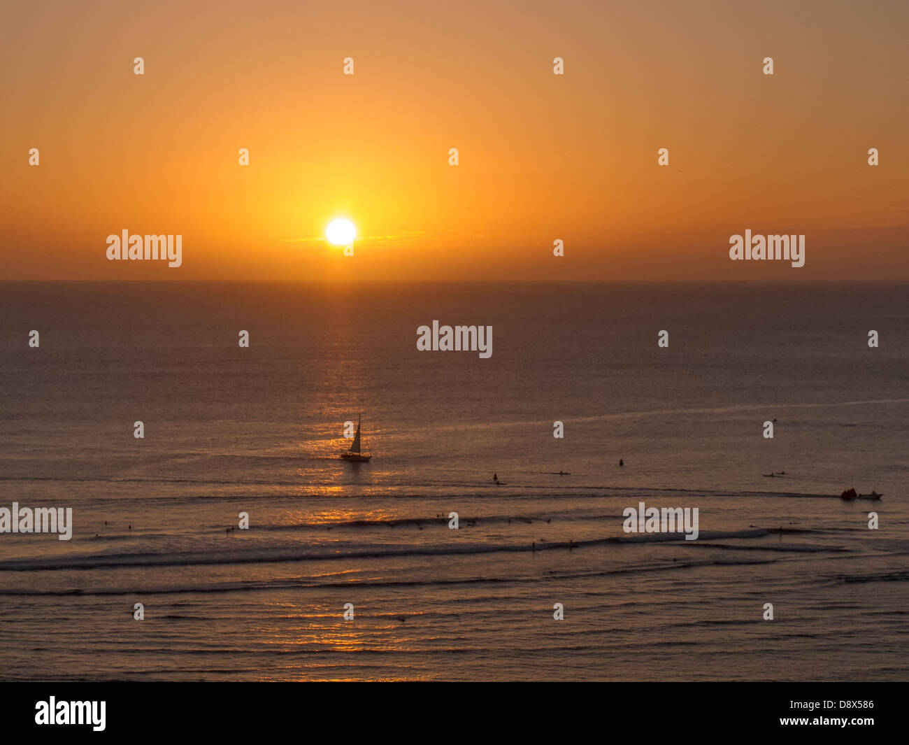 Sunset off of Waikiki with golden highlights reflected in the water Stock Photo