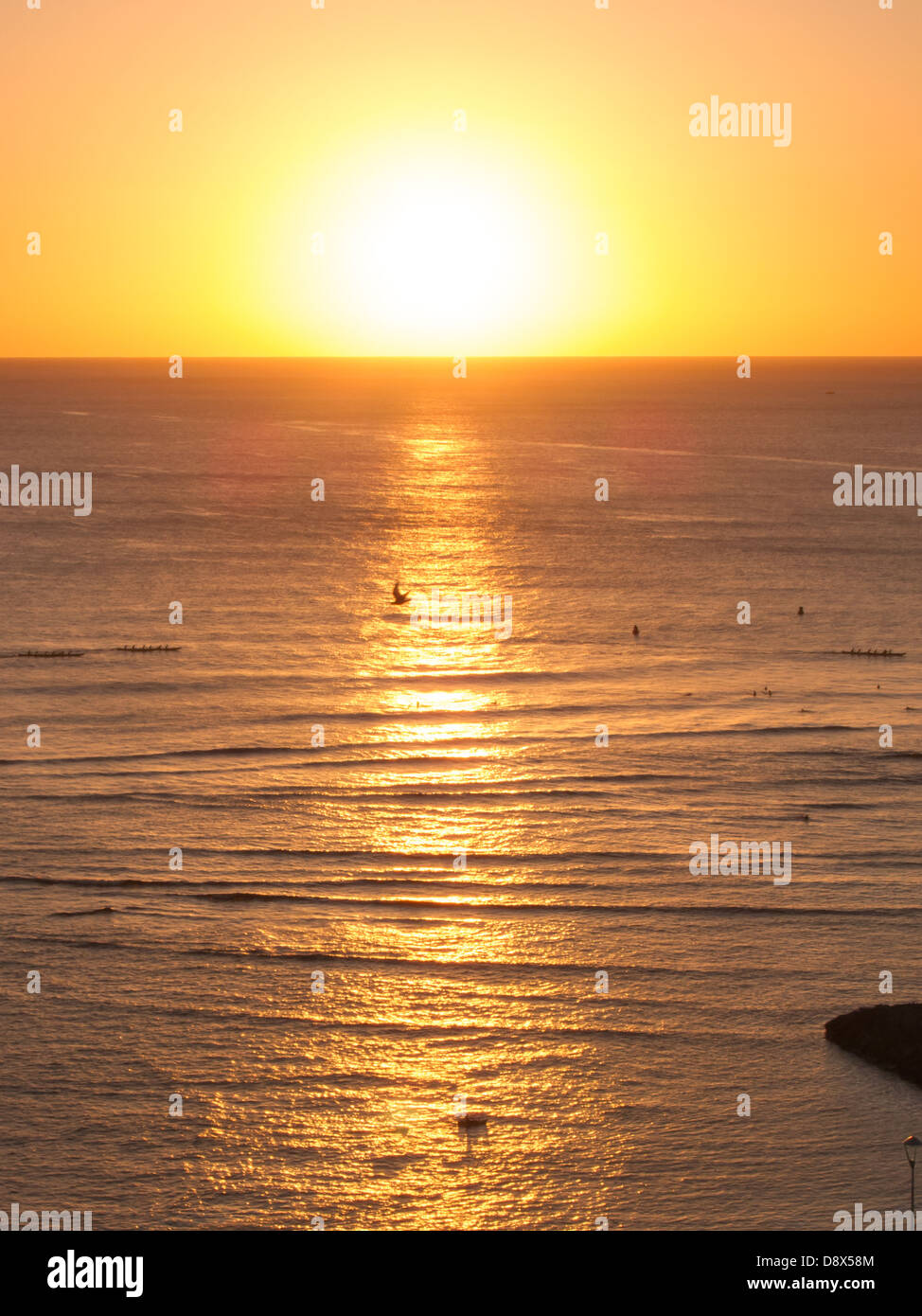Sunset off of Waikiki with golden highlights reflected in the water Stock Photo