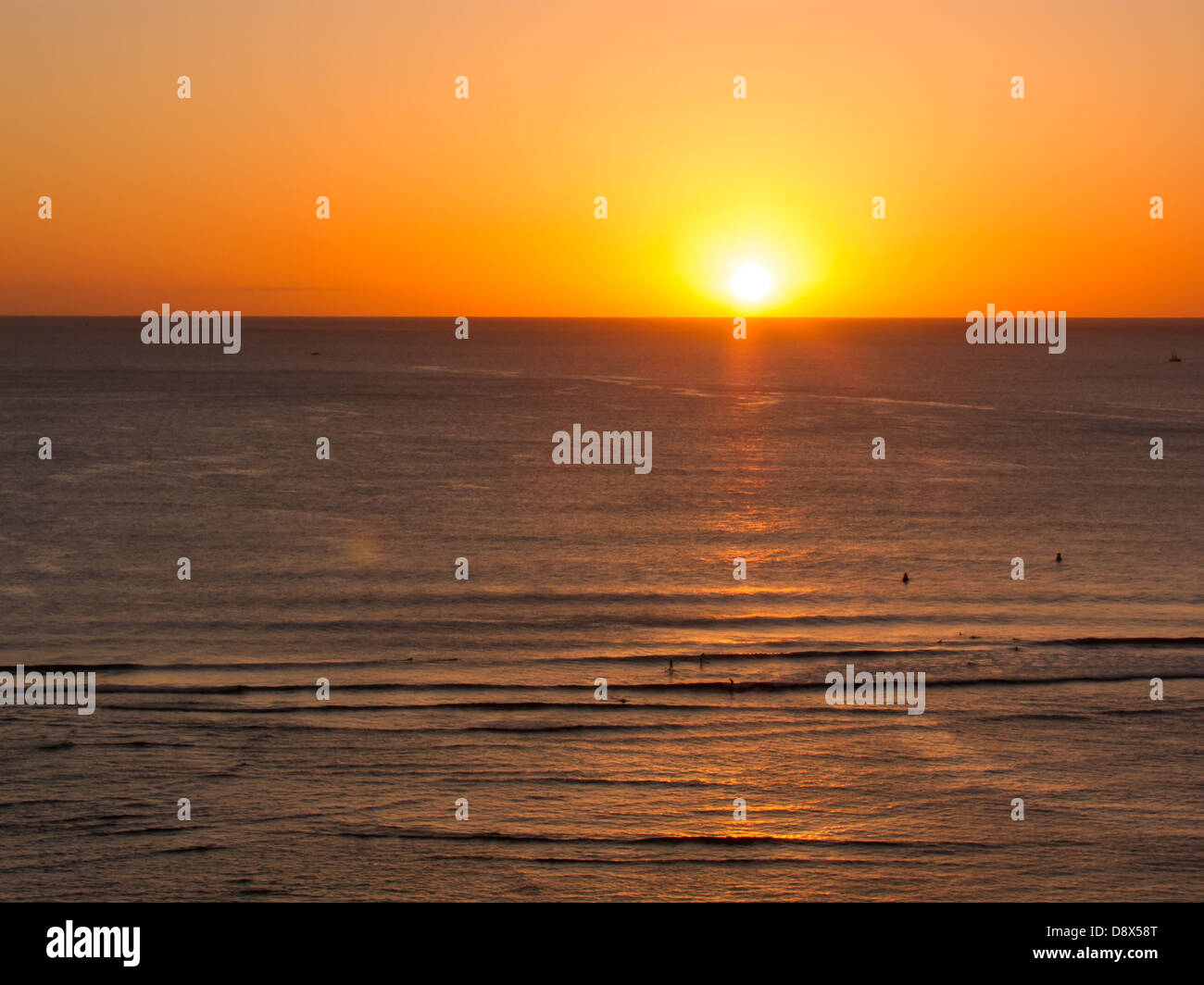 Sunset off of Waikiki with golden highlights reflected in the water Stock Photo