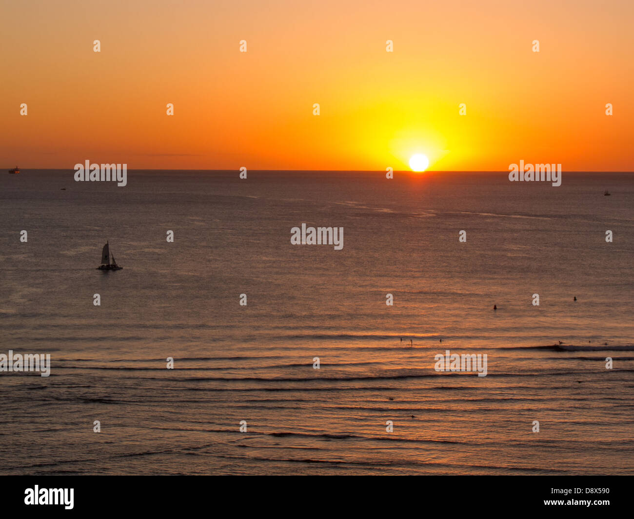 Sunset off of Waikiki with golden highlights reflected in the water Stock Photo