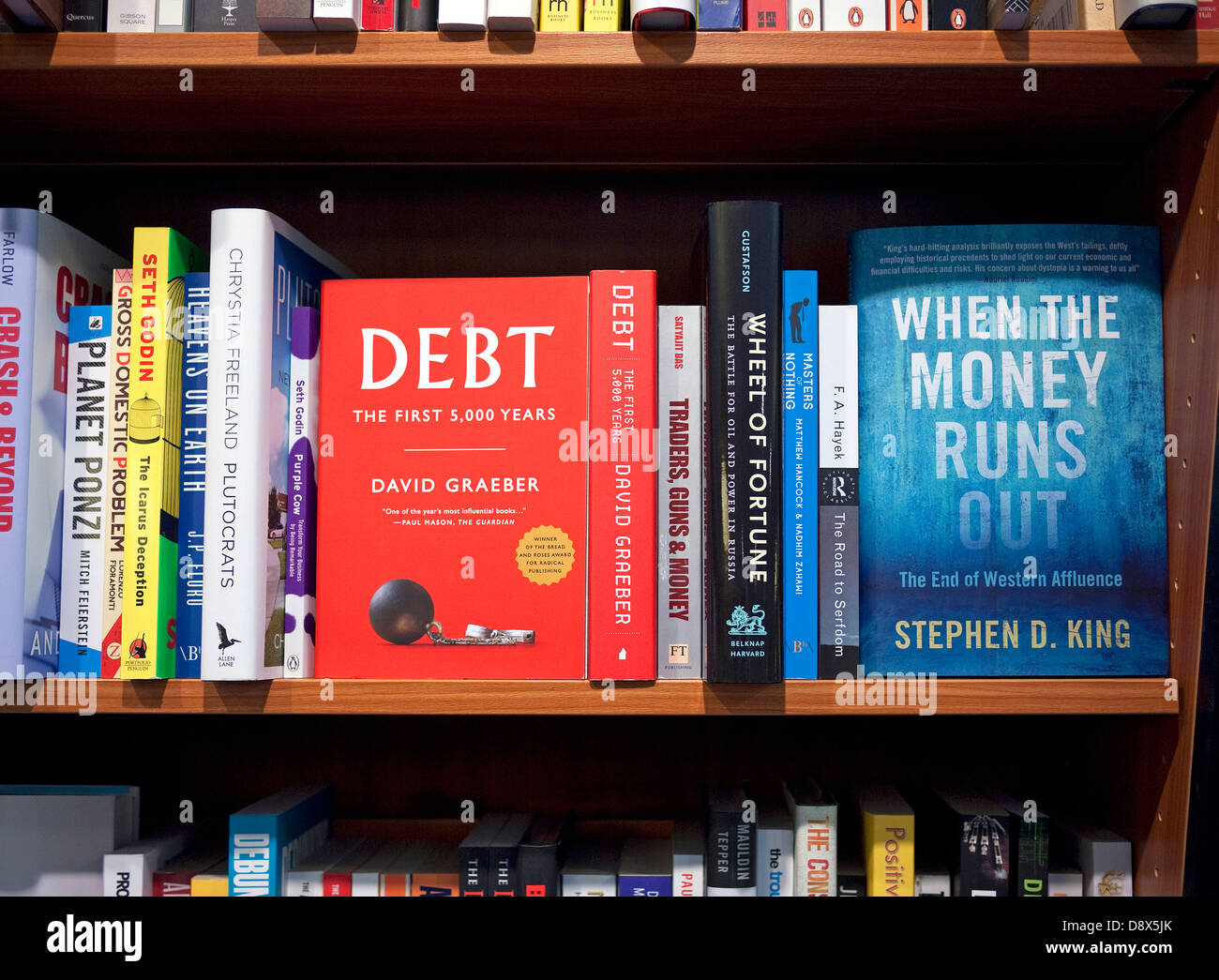 money and debt books on shelf in book shop Stock Photo Alamy