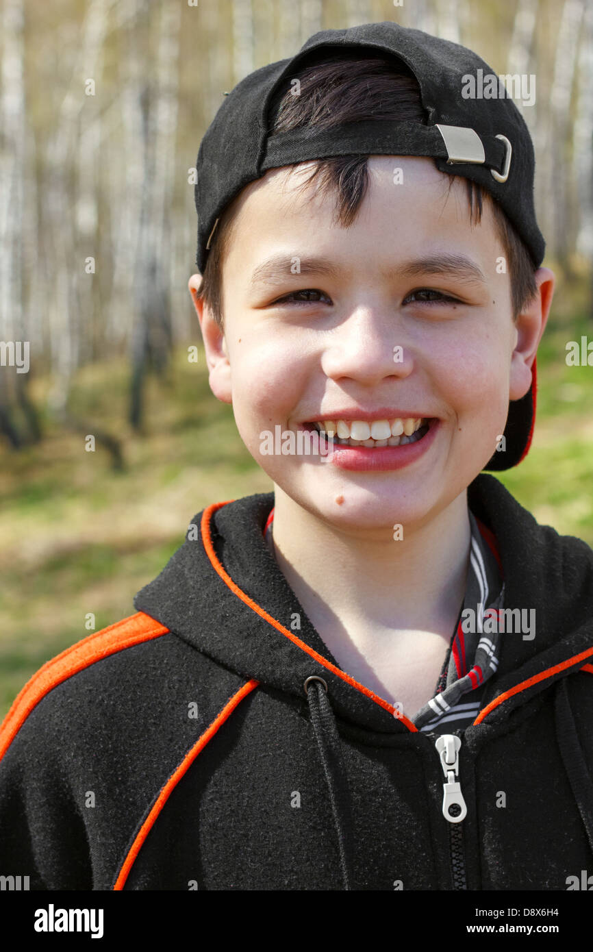 close-up portrait of laughing little boy in spring birch grove Stock Photo