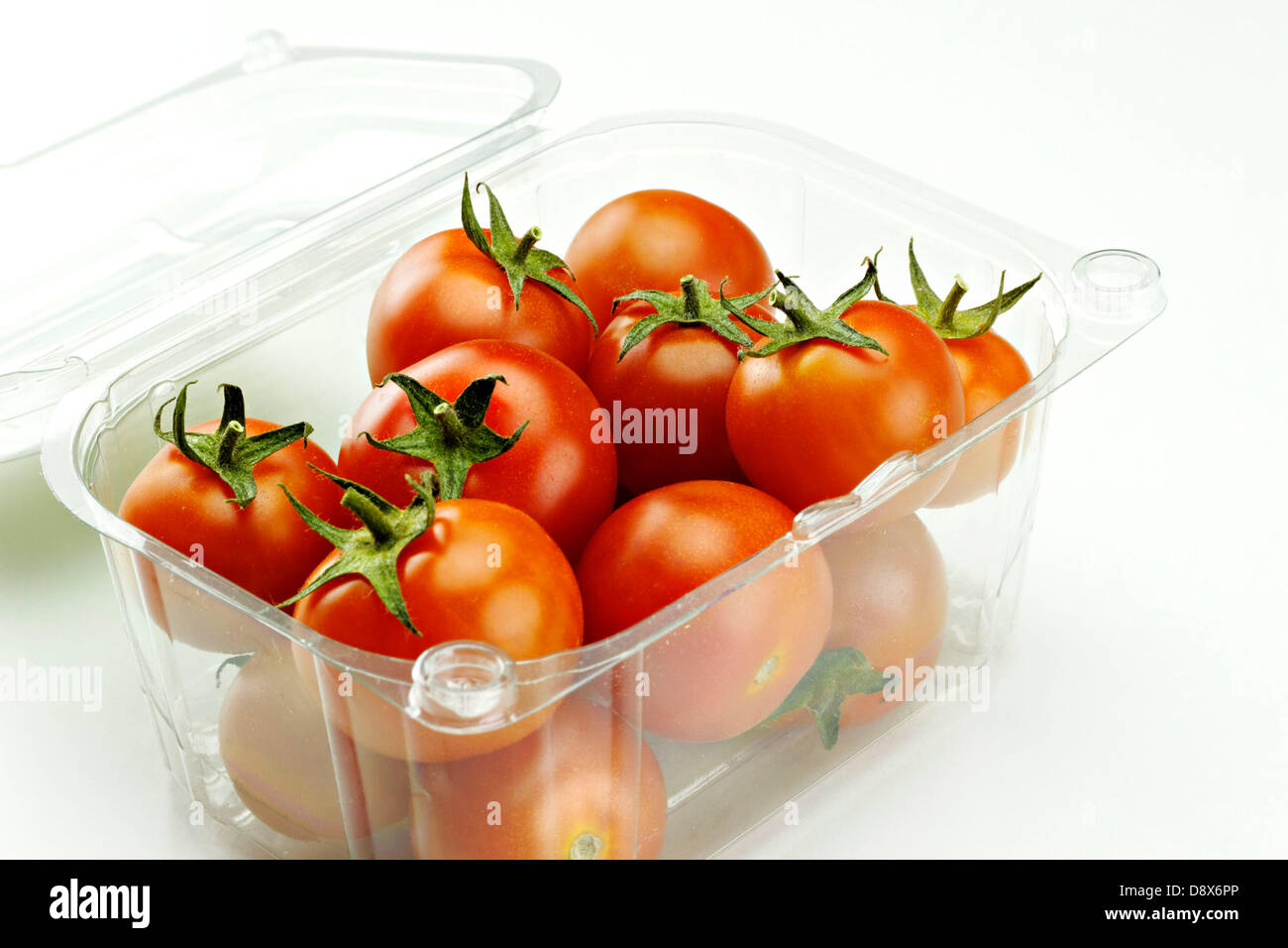 Red Tomatoes in a clear plastic container Stock Photo - Alamy