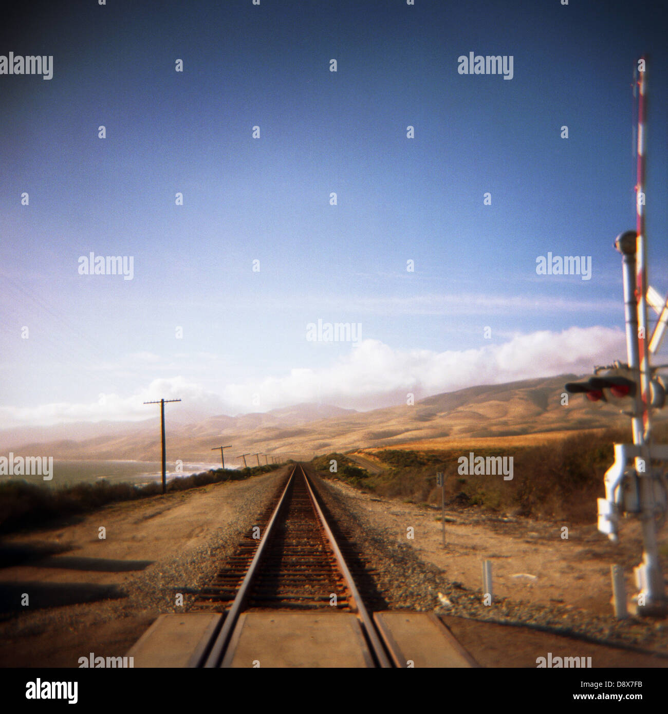 straight coastal railroad track crossing photographed on medium format square film along the California coast Stock Photo