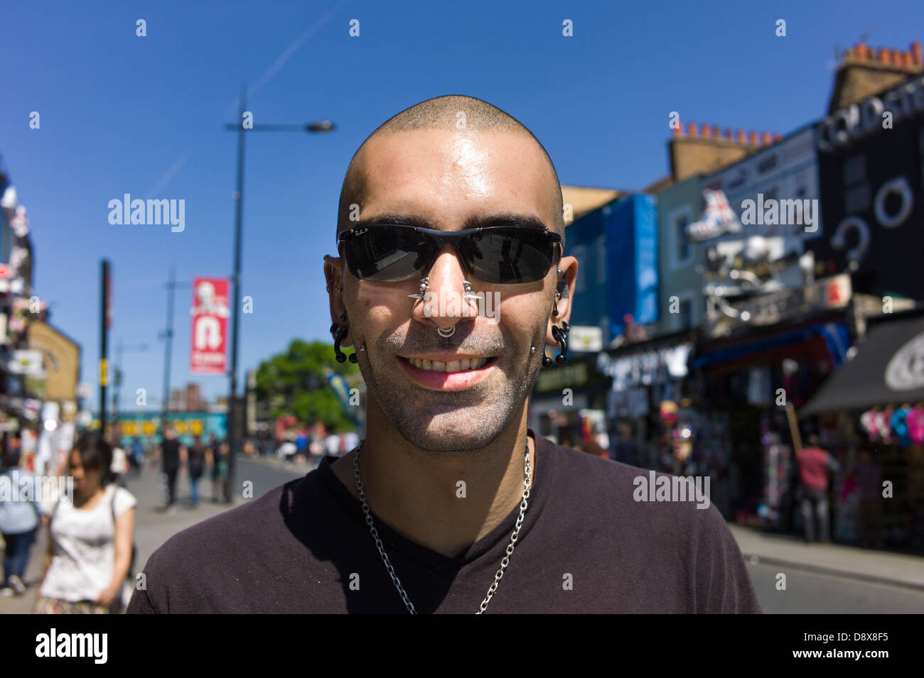 London UK, Camden Town, Camden Market, a man tourist, shopper with crew cut hair and wearing sunglasses posses for a portrait. Stock Photo