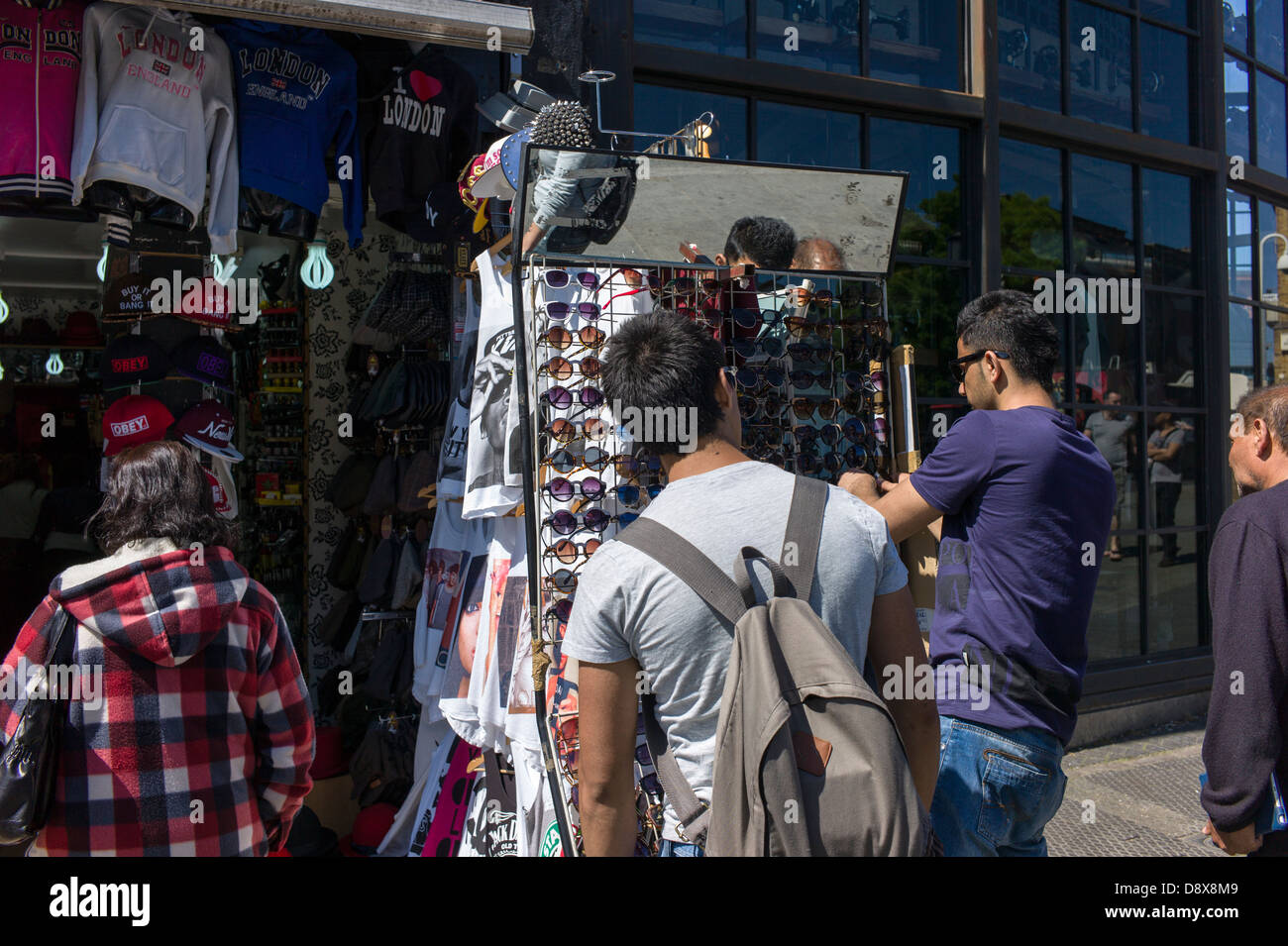 London UK, Camden Town, Camden Market, sun glasses stall, shop, tourist, shoppers, buying sunglasses. Stock Photo