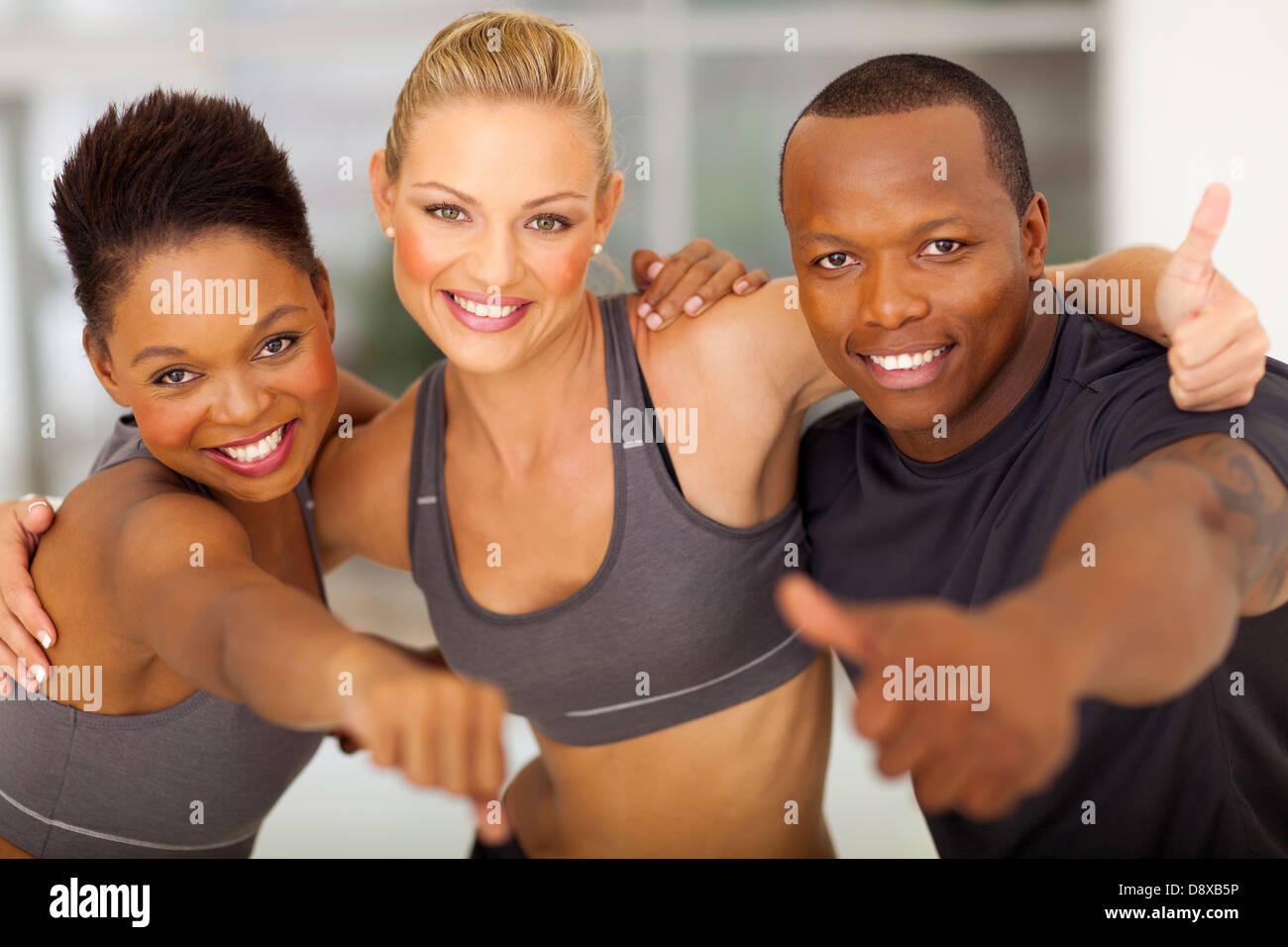 happy gym team giving thumbs up Stock Photo