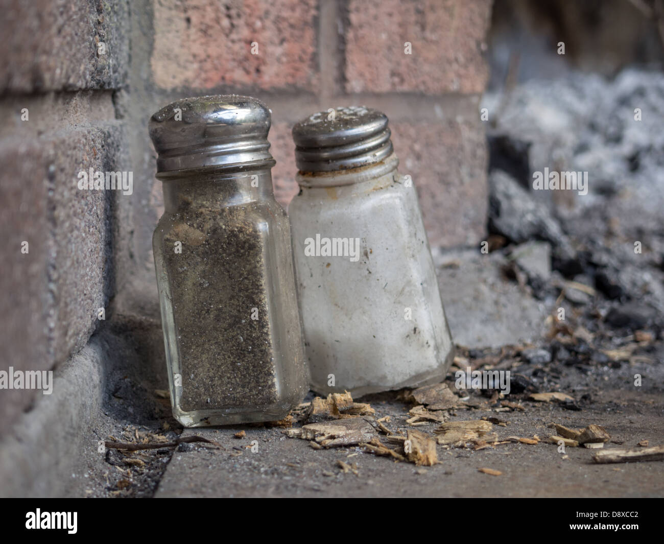 salt and pepper bottles in front of brick barbecue Stock Photo Alamy