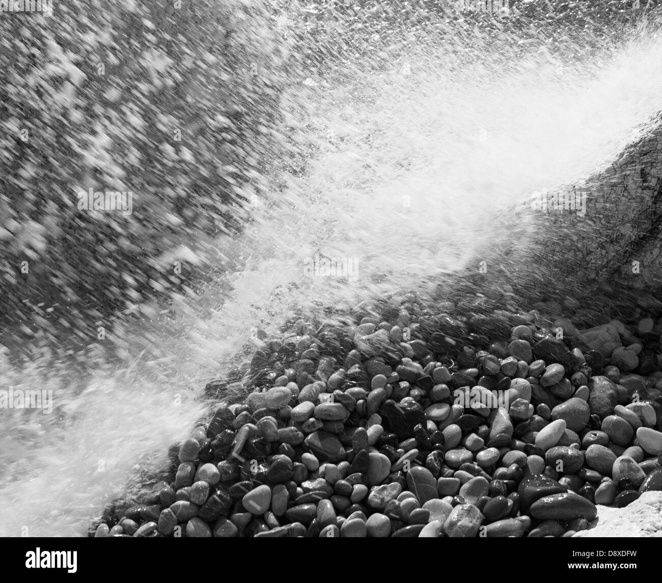 Water splashing on pebbles (B&W) Stock Photo