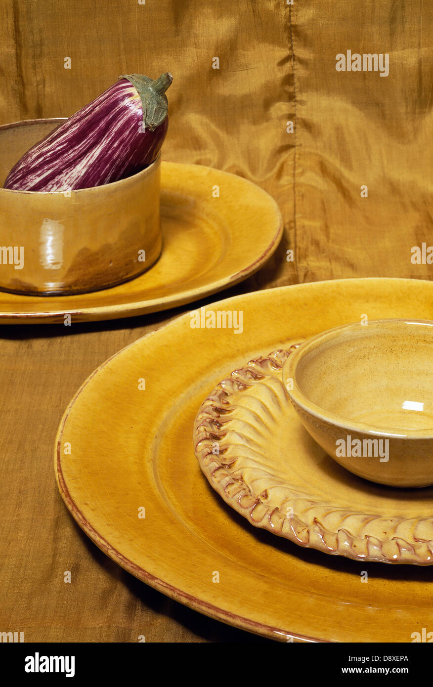 Eggplant with yellow plate and bowl Stock Photo Alamy