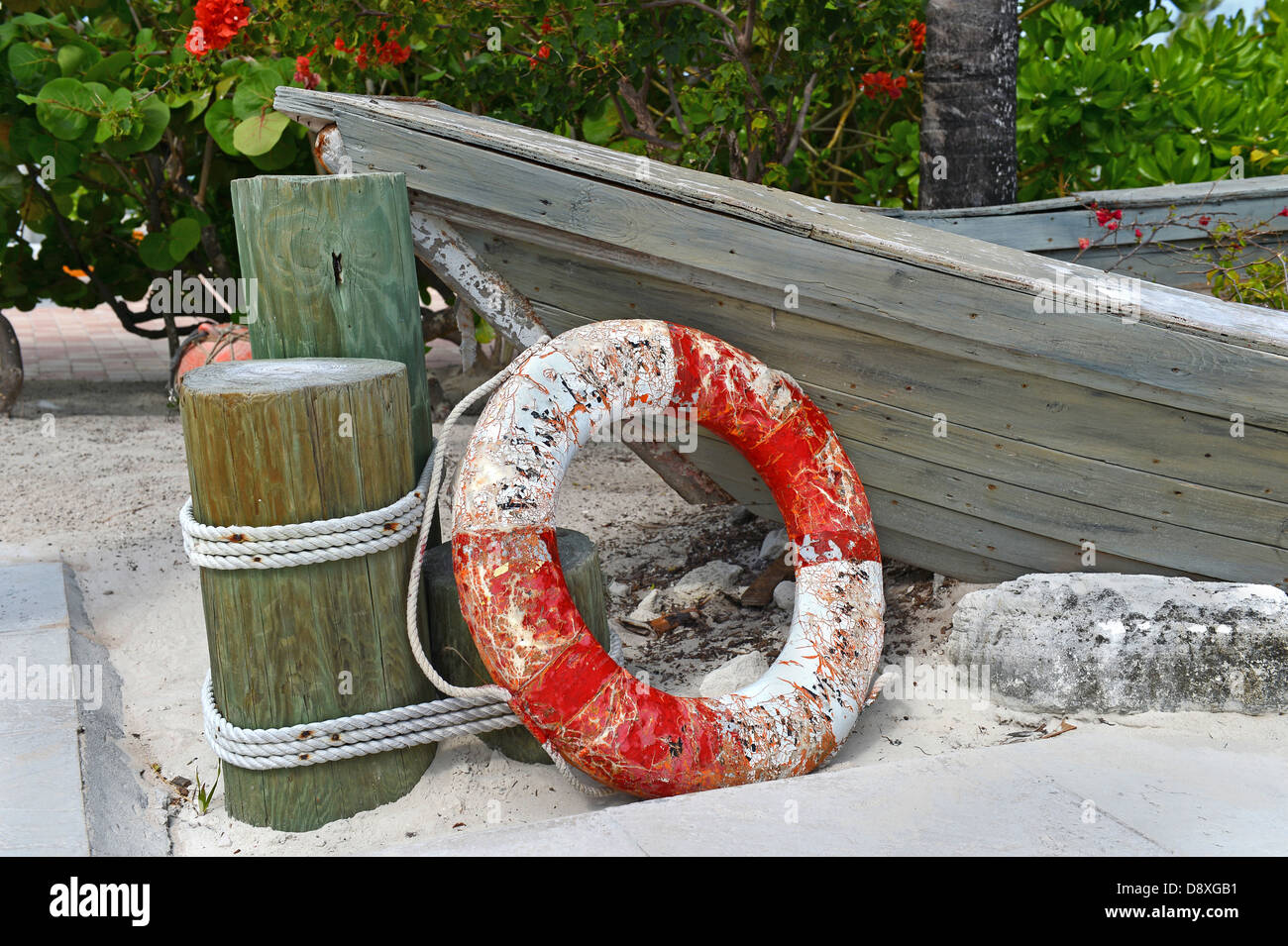 Old life ring and wooden boat on shore Stock Photo