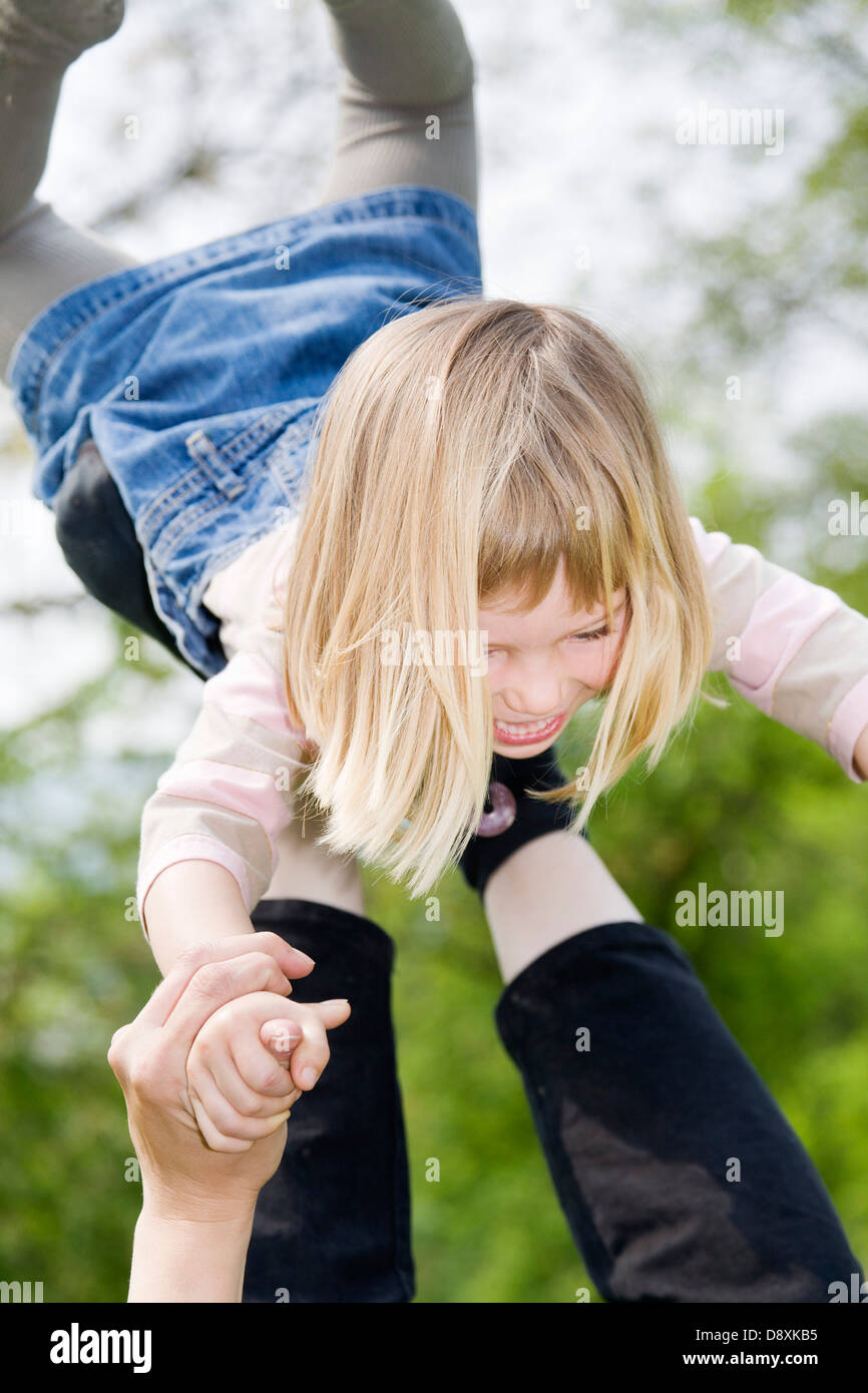 Four year-old girl swirling around by his mother Stock Photo