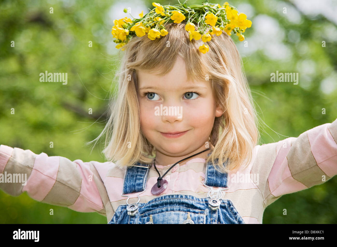 Four year-old girl with a wreath of flowers on her head Stock Photo