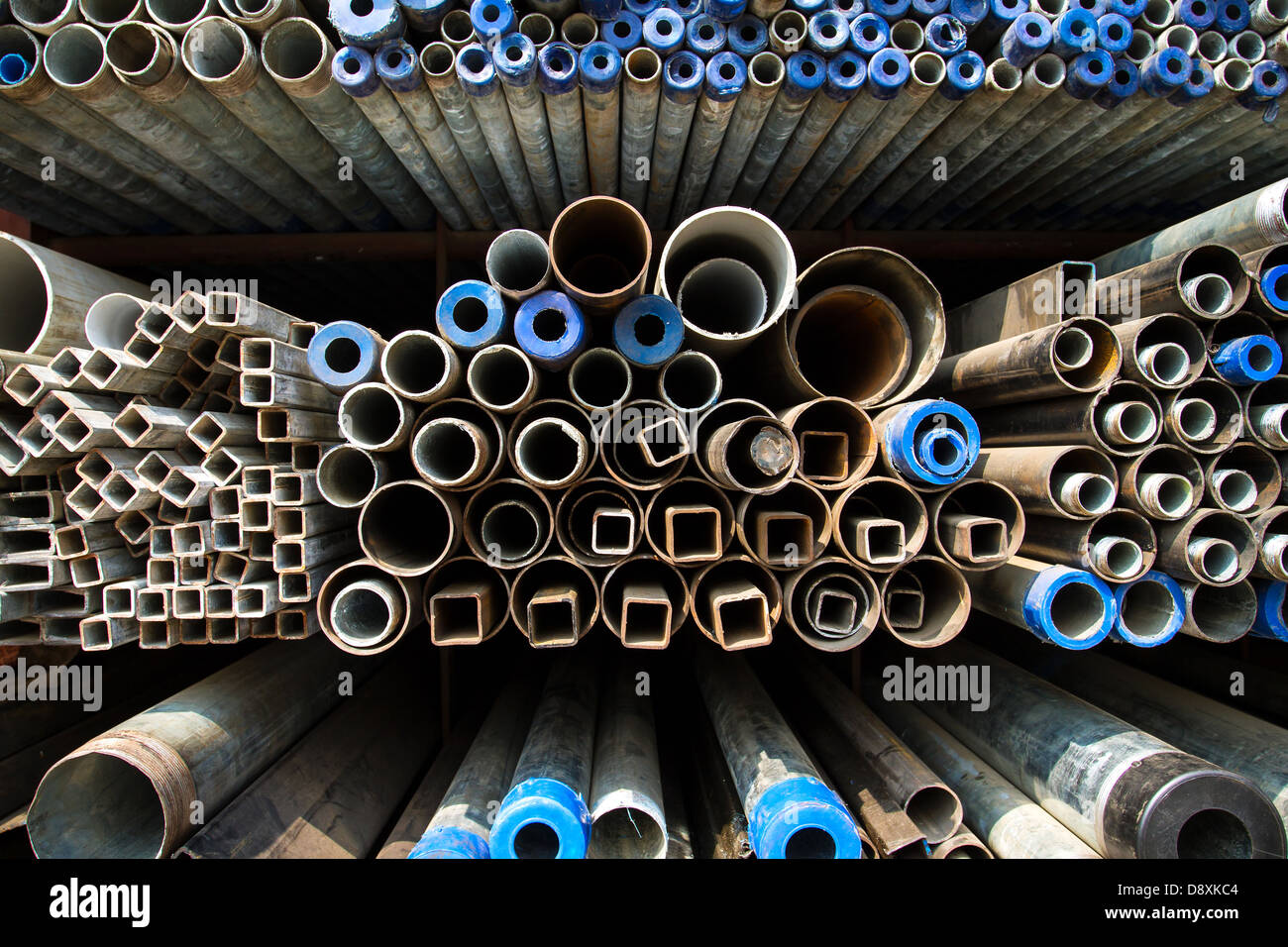 Stacked steel pipes and tubes background Stock Photo