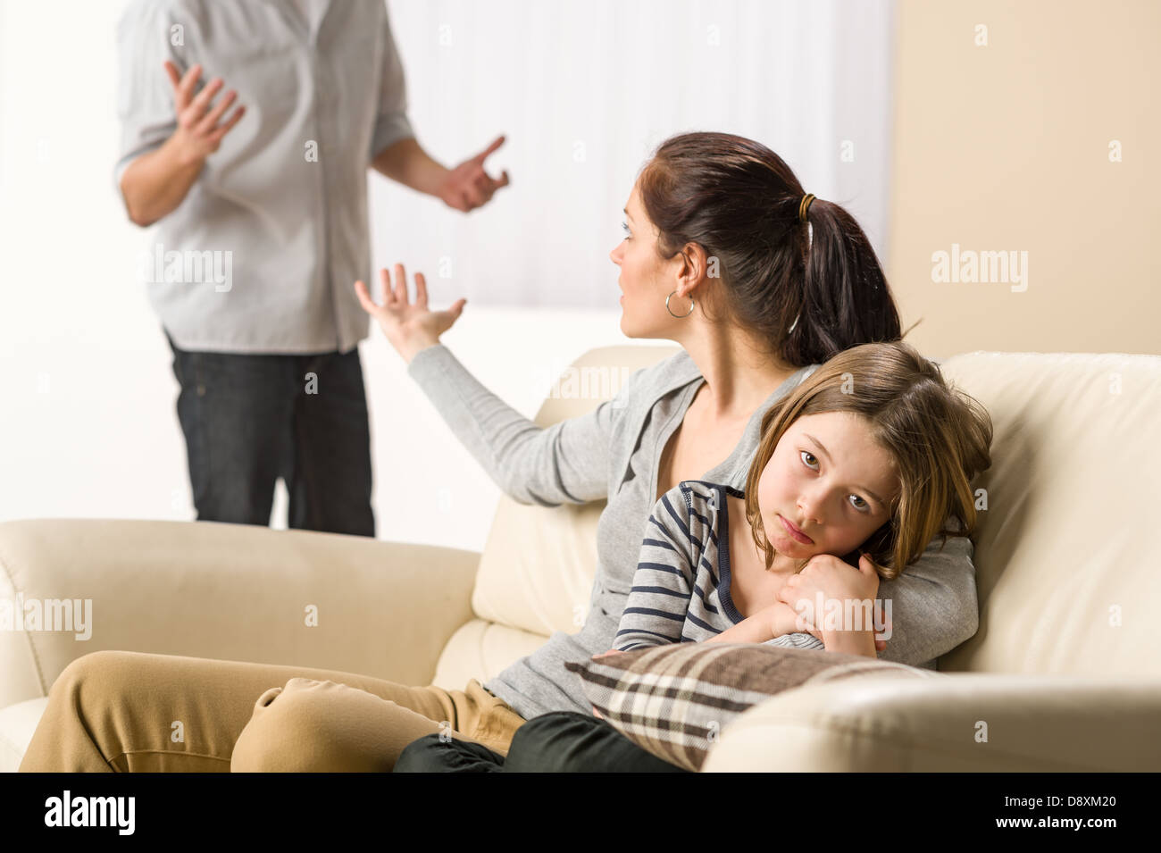Arguing parents with upset little girl Stock Photo