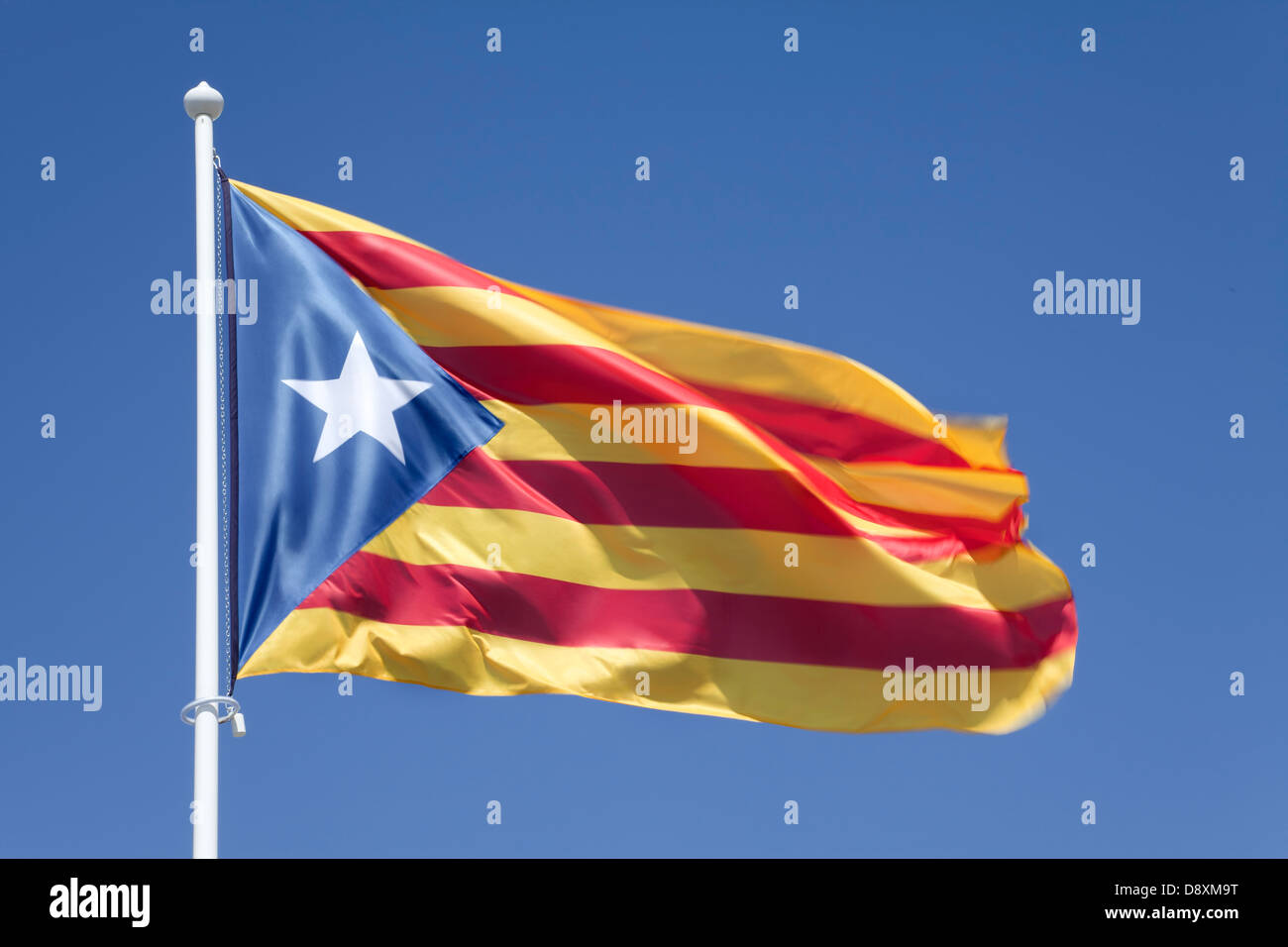 Catalonia independent flag on blue sky. Symbol of the Catalan independence movement Stock Photo