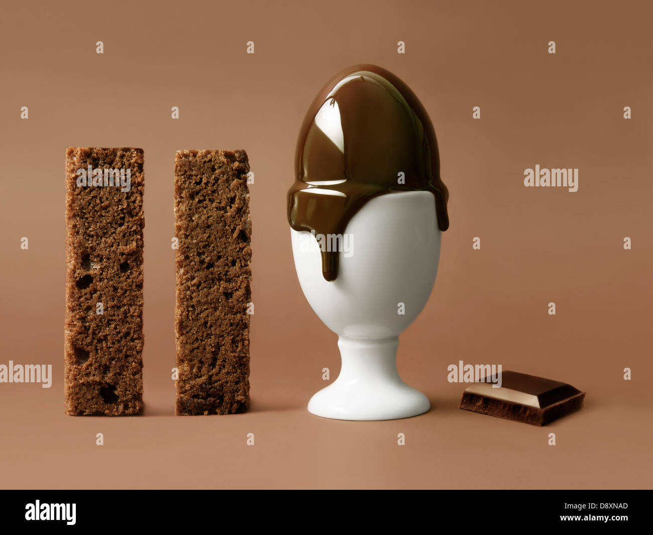 Melting chocolate egg in an eggcup Stock Photo