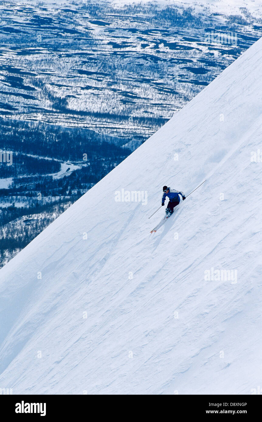 A skier going downhill Stock Photo Alamy