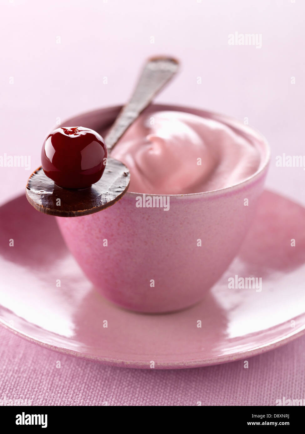 Cherry liqueur whipped cream and a spoonful of chocolate Stock Photo