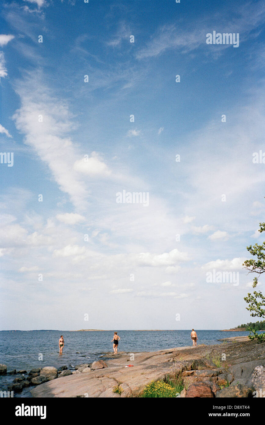 Three grown-ups taking a swim, Sweden. Stock Photo