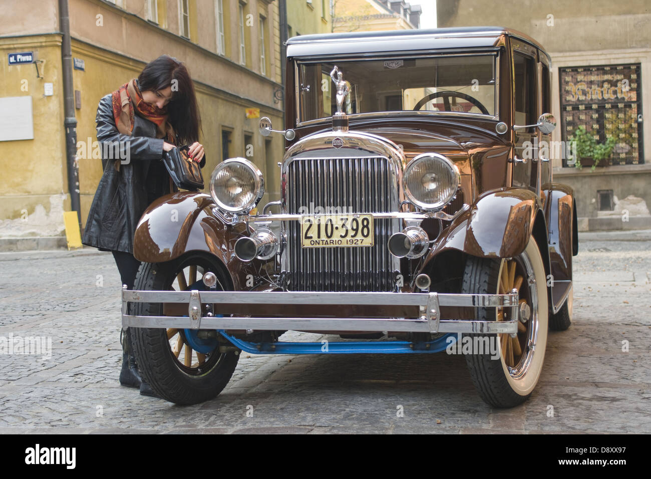 Oldtimer car Essex Super Six and young woman on Old Town in Warsaw, Poland Stock Photo