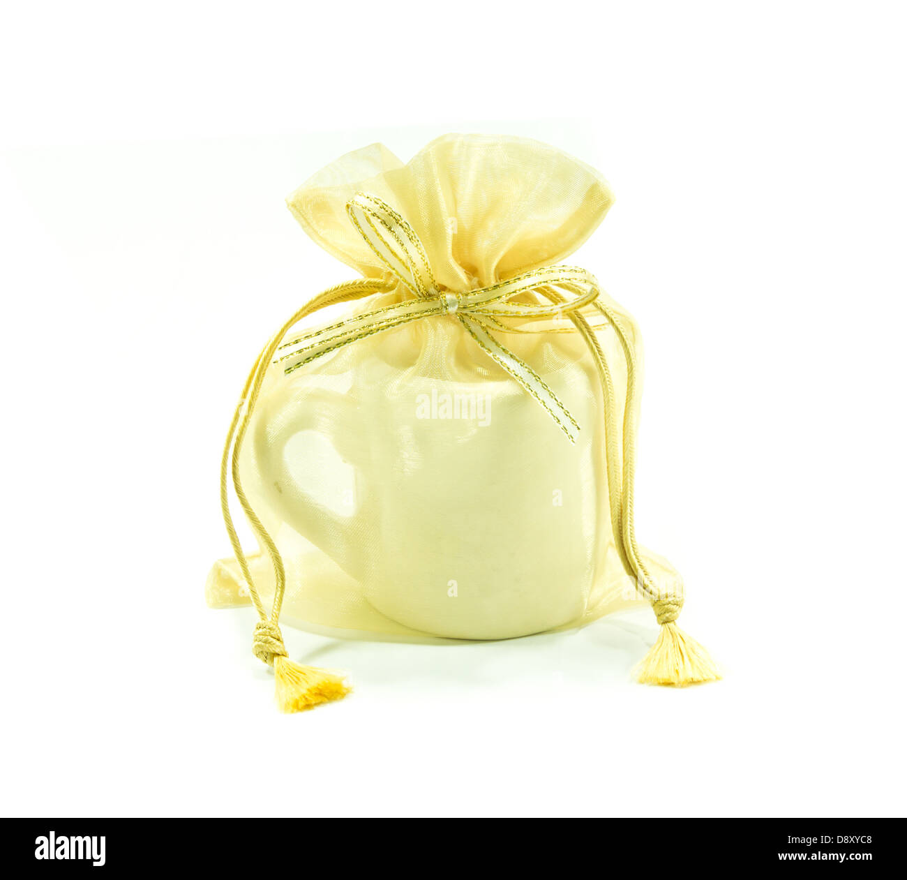 The cup in golden mesh bag as wedding souvenir isolated on white ...