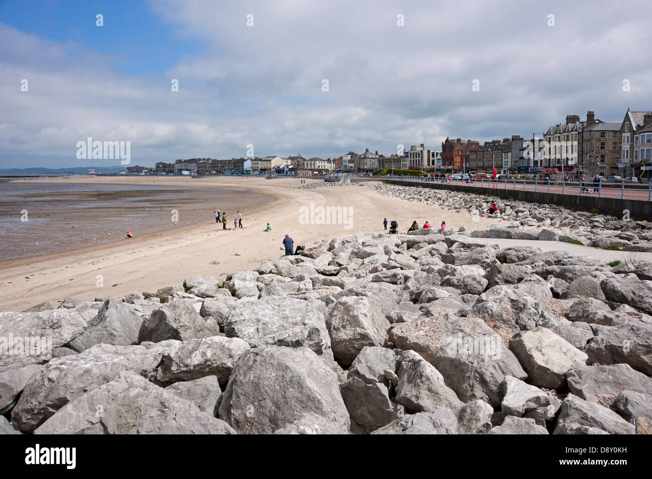People tourists visitors on the beach sands sand at low tide seafront seaside resort Morecambe Bay Lancashire England UK United Kingdom Great Britain Stock Photo