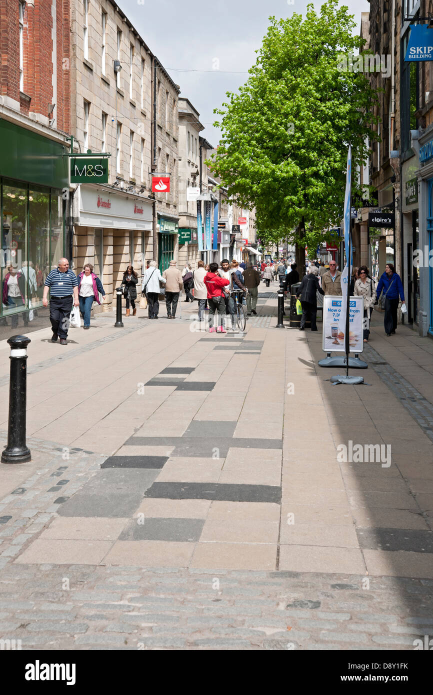 People shoppers walking along pedestrianised Penny Street in the city town centre Lancaster Lancashire England UK United Kingdom GB Great Britain Stock Photo