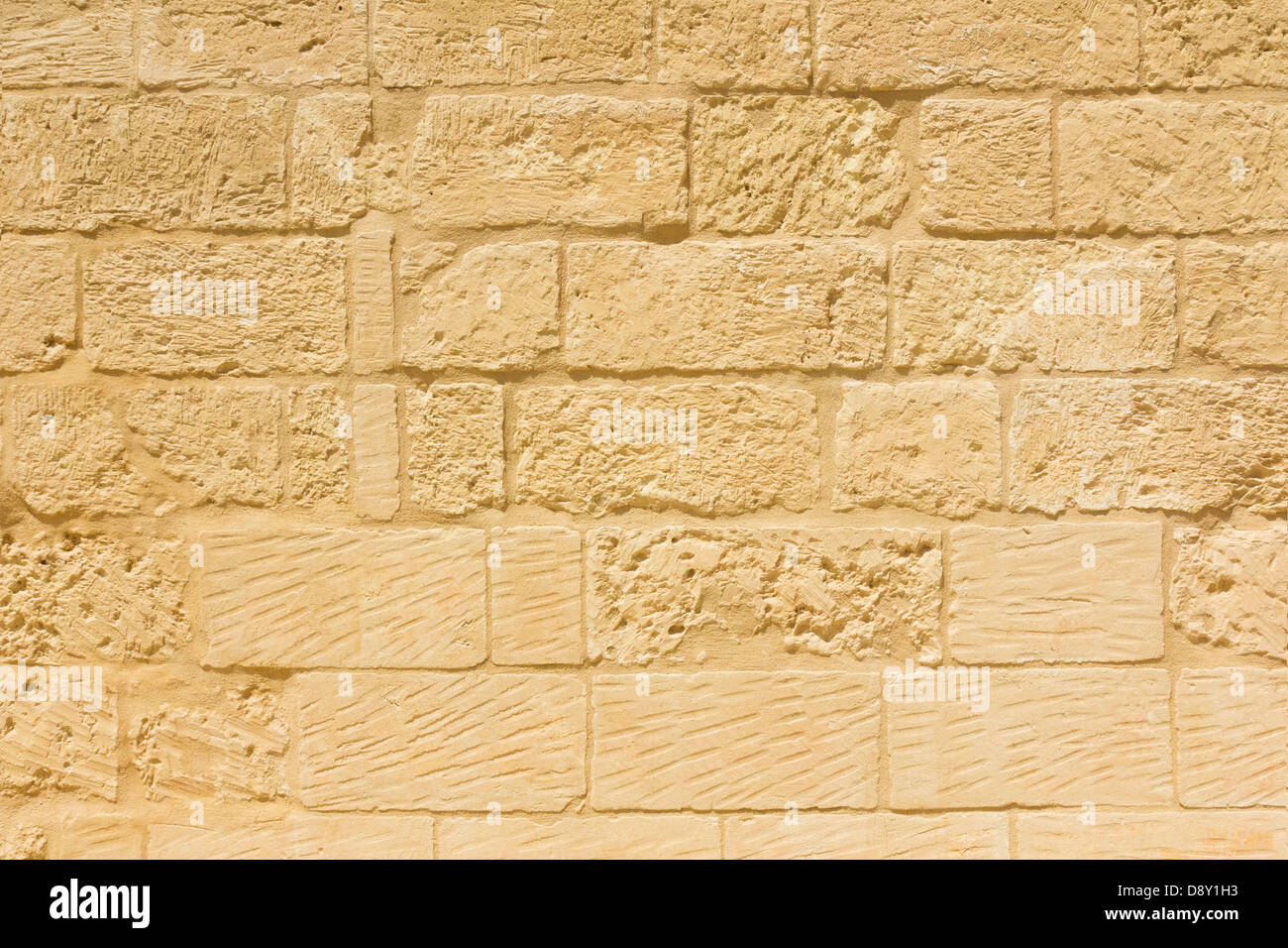 Weathered sandstone brick wall background Stock Photo