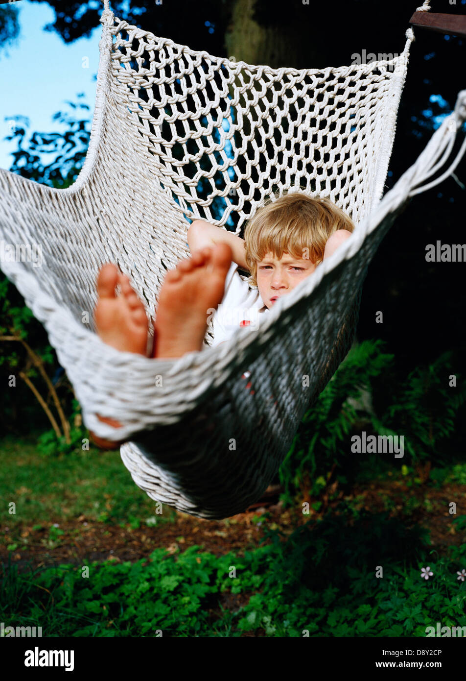 A boy lying in a hammock Stock Photo - Alamy