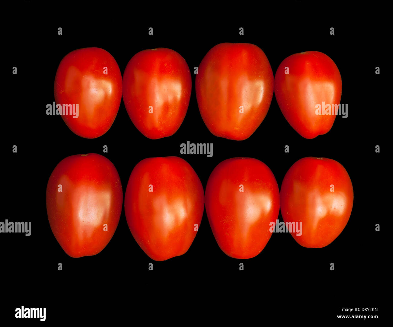 Red cherry tomatoes isolated on a black background Stock Photo - Alamy