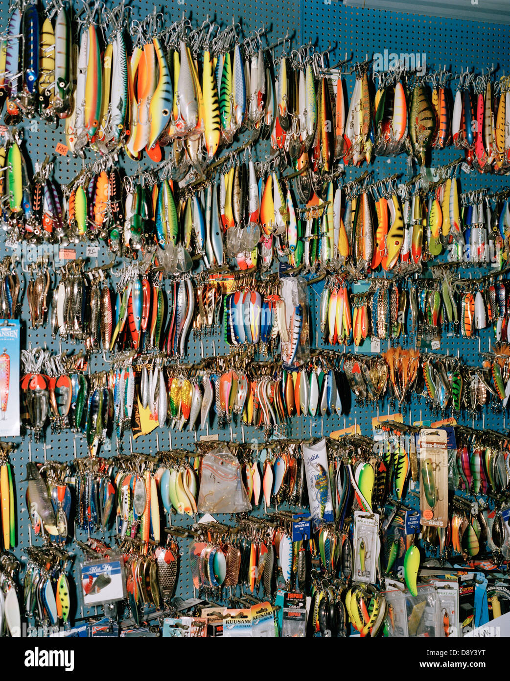 Fishing equipment on a wall in a fishing store. Stock Photo