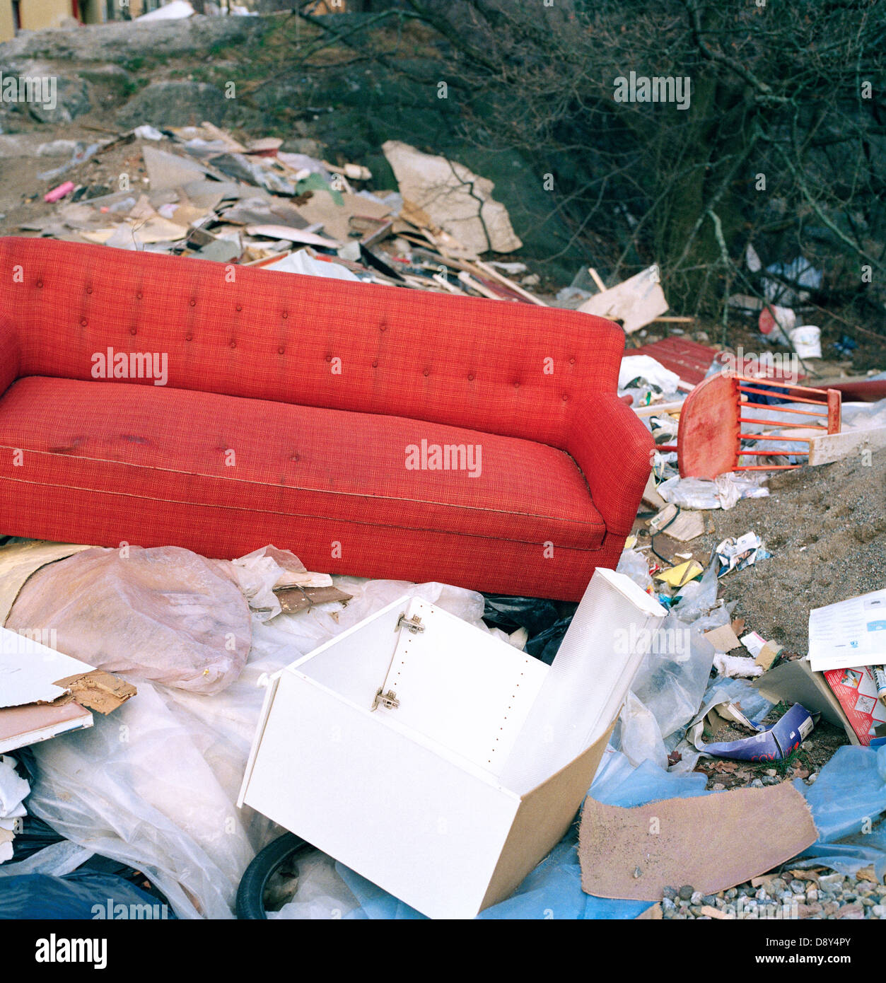 Red couch in a refuse dump Stock Photo Alamy