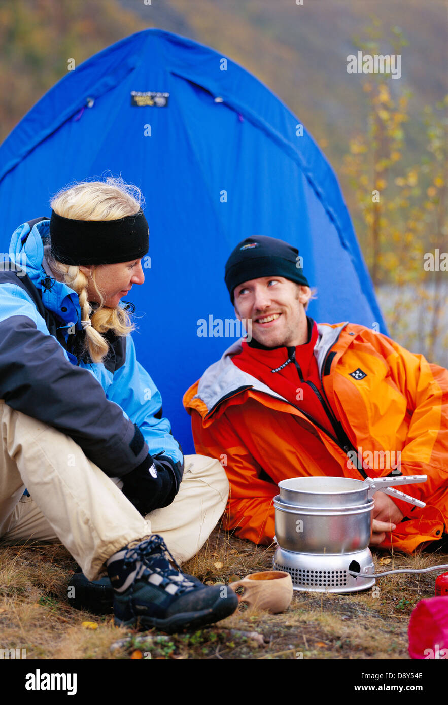 A man and a woman camping Stock Photo - Alamy