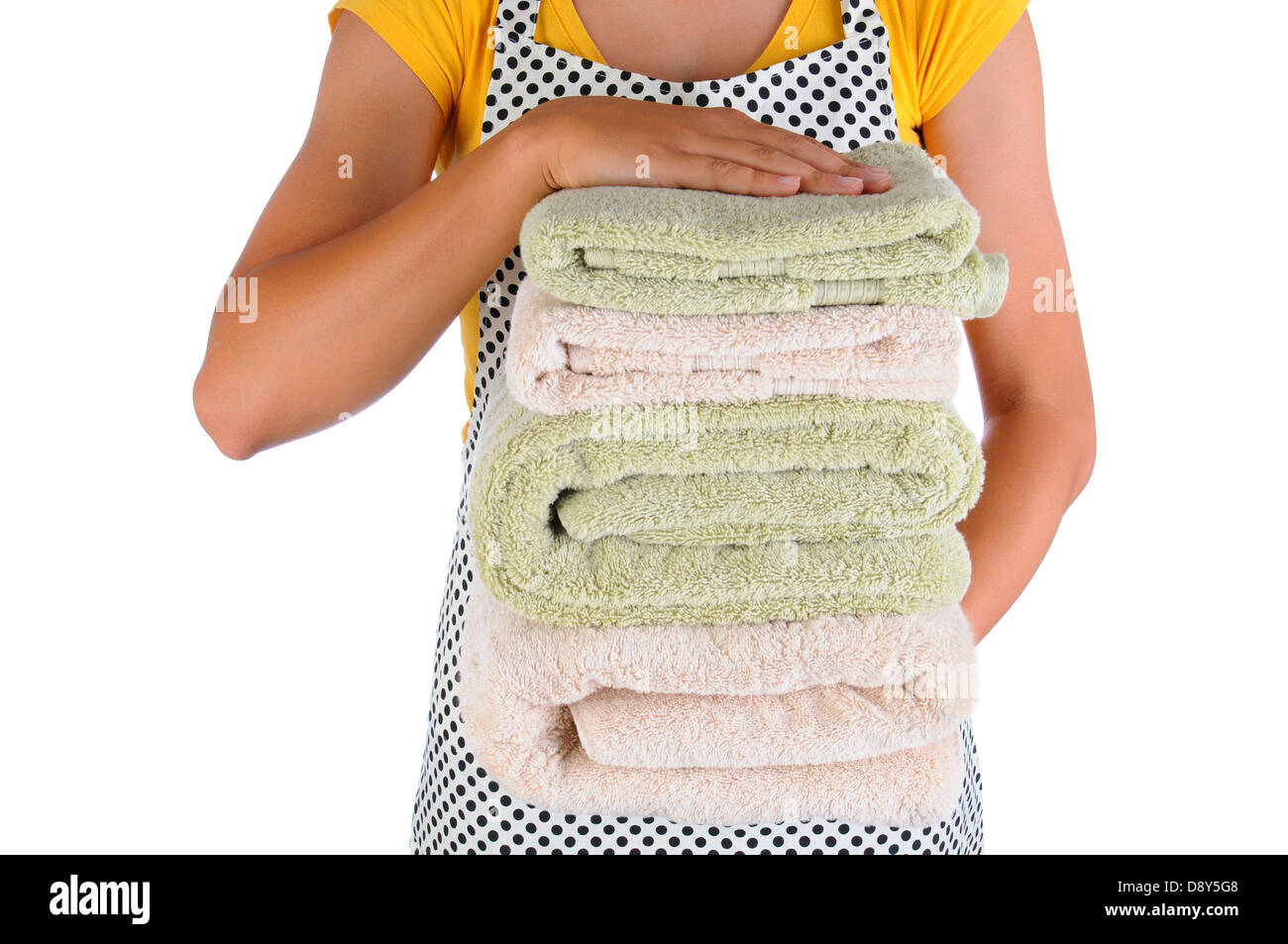 Closeup of a housewife holding a stack of freshly laundered towels. Woman is unrecognizable. Stock Photo