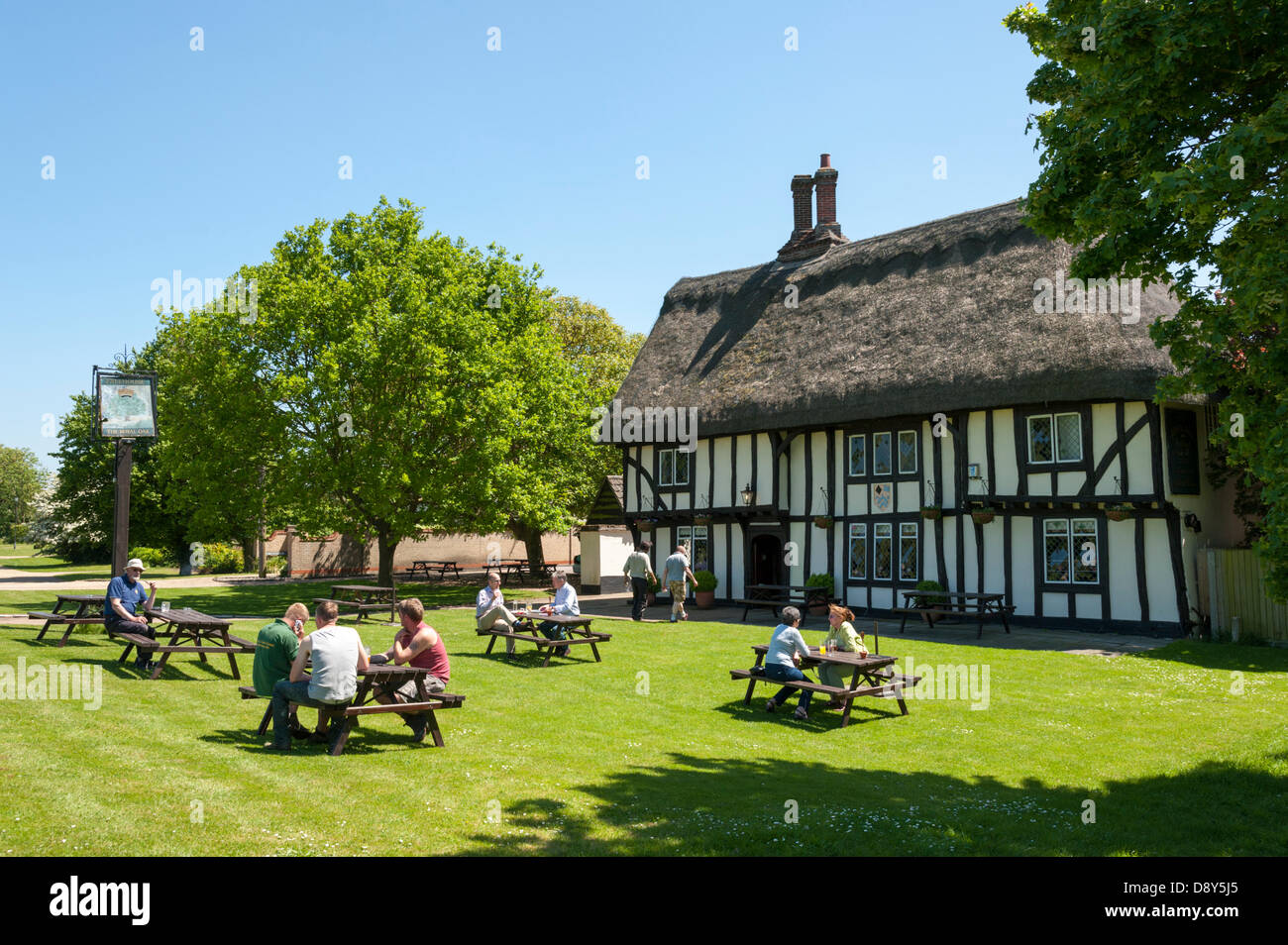 Barrington, Cambridgeshire, UK. 6th June 2013. People make the most of the warm sunny weather with lunchtime  drinks and food in the garden of the Royal Oak pub in Barrington, South Cambridgeshire, UK,  6th June 2013.The quintessentially English, thatched pub of Tudor design dates back to the 16th Century. It overlooks a village green that covers 30 acres, more than half a mile long, supposedly the longest in England. The good weather is set to continue over the weekend. Credit Julian Eales/Alamy Live News Stock Photo
