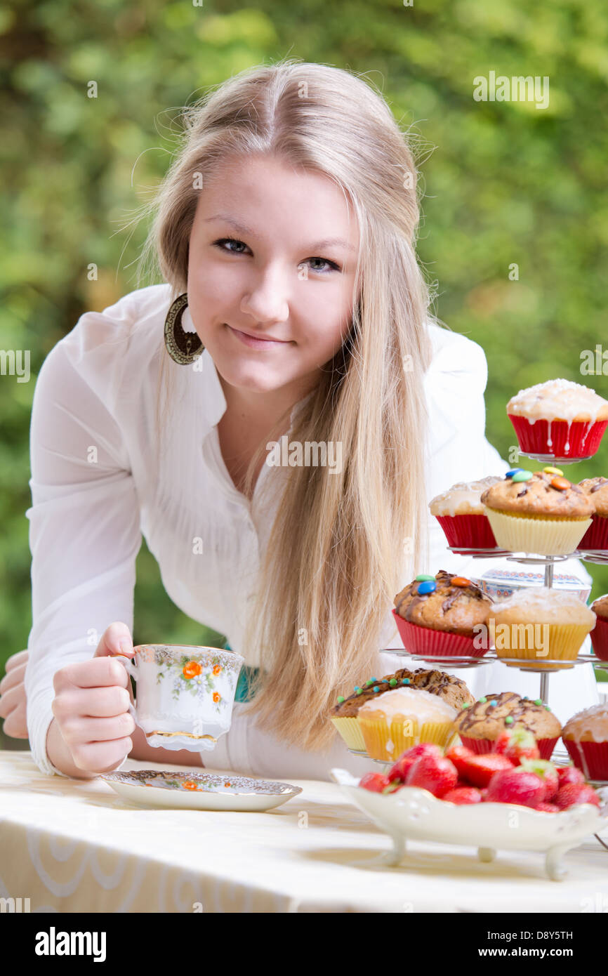 young teenage girl eating on a patio Stock Photo
