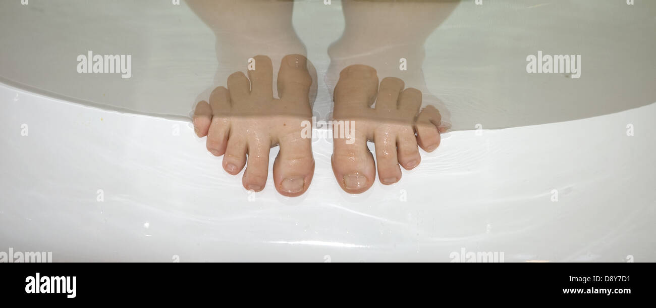 Toes sticking up out of the bathwater. Stock Photo
