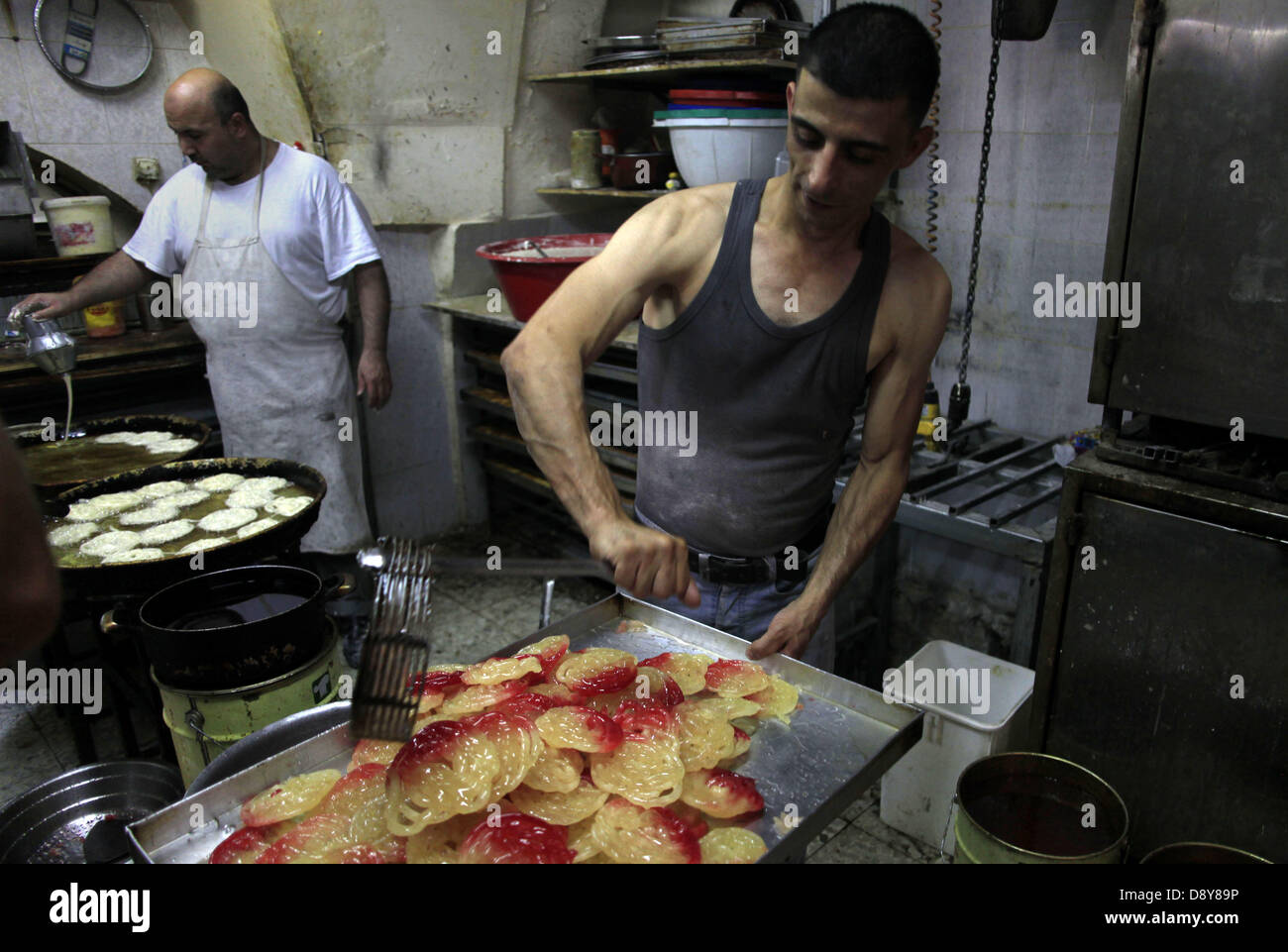 June 6, 2013 - Jerusalem, West Bank, Palestinian Territory - Palestinian workers make traditional sweets 'Mushabak', during celebration the Islamic holiday of Isra Mi'raj in Jerusalem on June 06, 2013. The holiday marks what Muslims believe is Prophet Mohammad's journey from Mecca to Jerusalem and it is believed to be followed by his ascension to heaven  (Credit Image: © Saeed Qaq/APA Images/ZUMAPRESS.com) Stock Photo