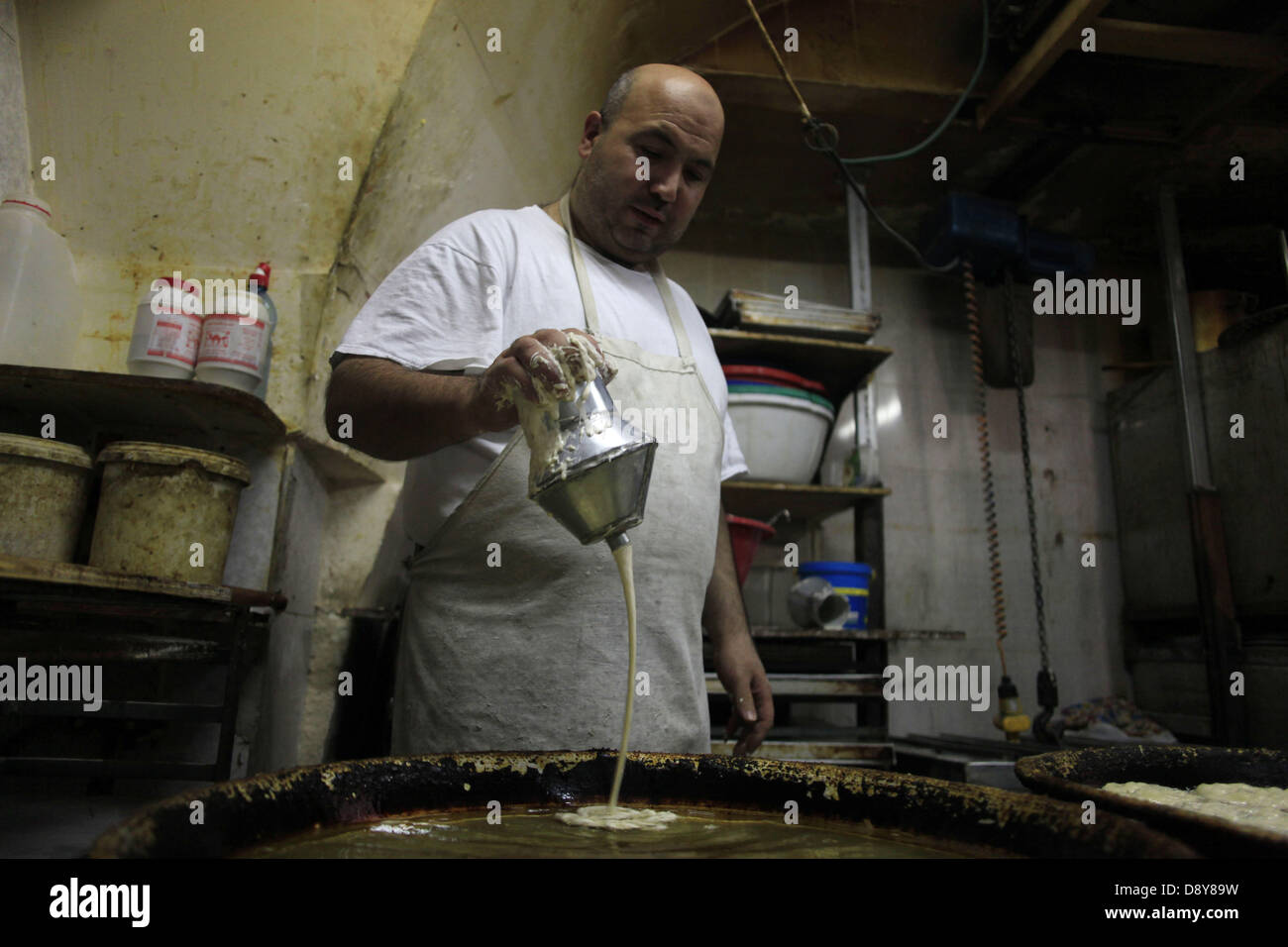 June 6, 2013 - Jerusalem, West Bank, Palestinian Territory - A Palestinian worker makes traditional sweets 'Mushabak', during celebration the Islamic holiday of Isra Mi'raj in Jerusalem on June 06, 2013. The holiday marks what Muslims believe is Prophet Mohammad's journey from Mecca to Jerusalem and it is believed to be followed by his ascension to heaven  (Credit Image: © Saeed Qaq/APA Images/ZUMAPRESS.com) Stock Photo