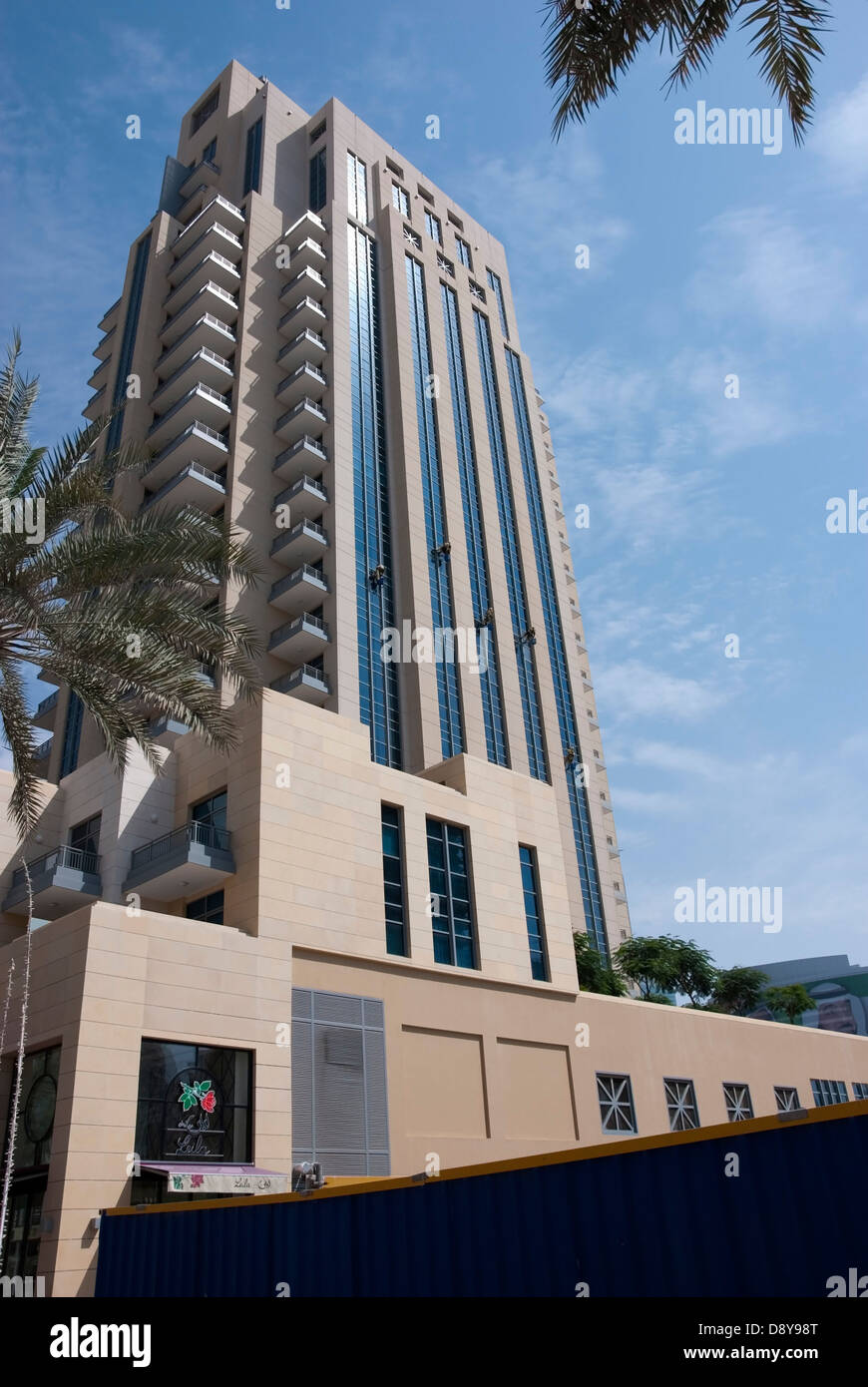 Five Window Cleaners Suspended on the Exterior of Clarens Tower Downtown Dubai Stock Photo
