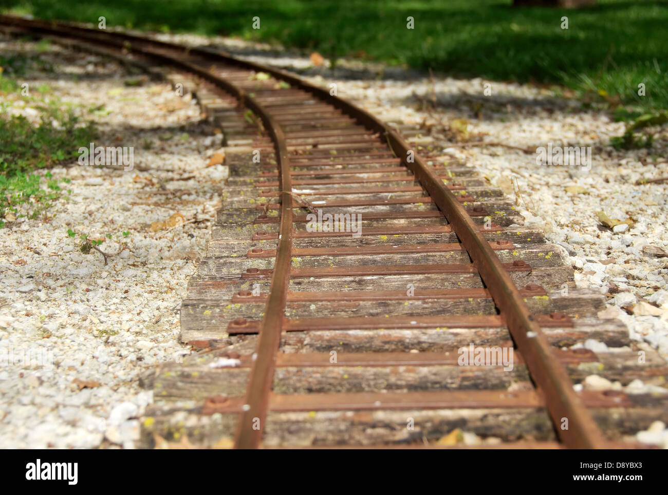 Rusty train tracks curving around a bend Stock Photo