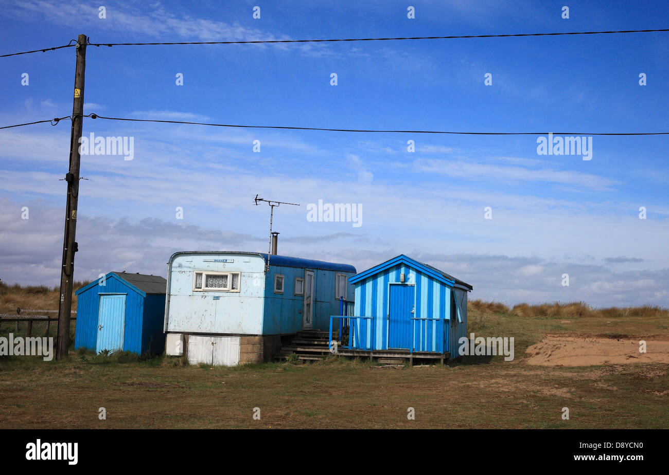 Blue caravan and sheds near the beach at Heacham, Norfolk, England, UK. Stock Photo