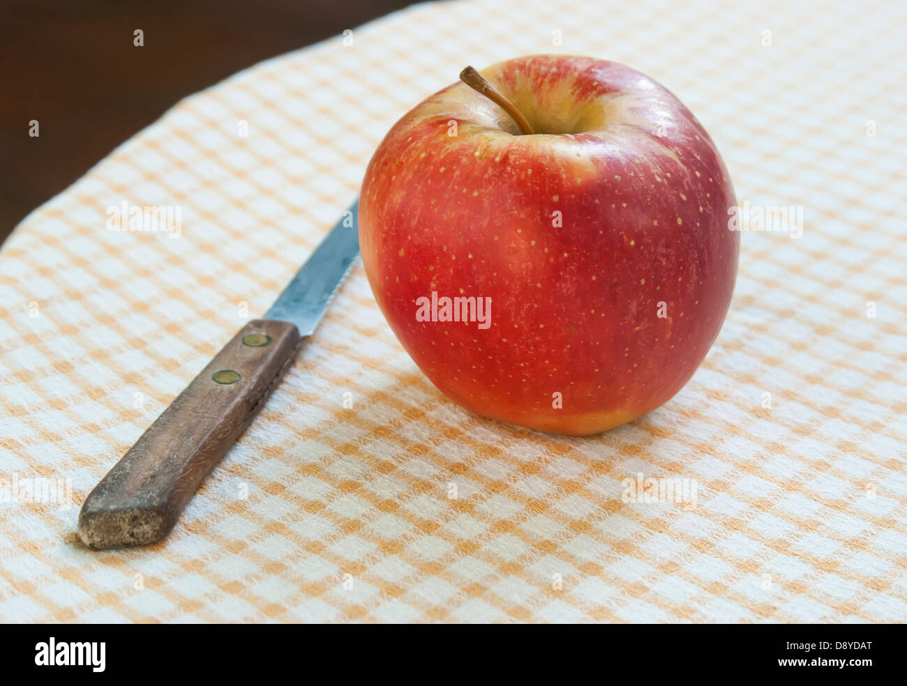 apple and knife on garden table Stock Photo