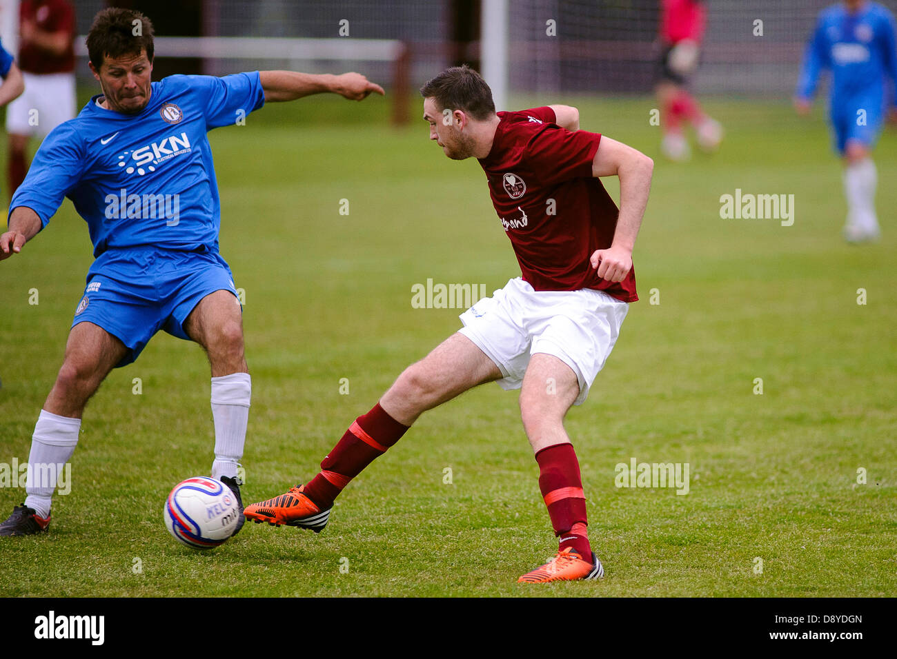 Kelty, Fife, Scotland, UK. 5th June 2013. Greg Kirk (left) and Brian Ritchie compete for the ball during the East Region Super league match, Kelty v Lochee at Central Park. Credit: Colin Lunn/Alamy Live News Stock Photo