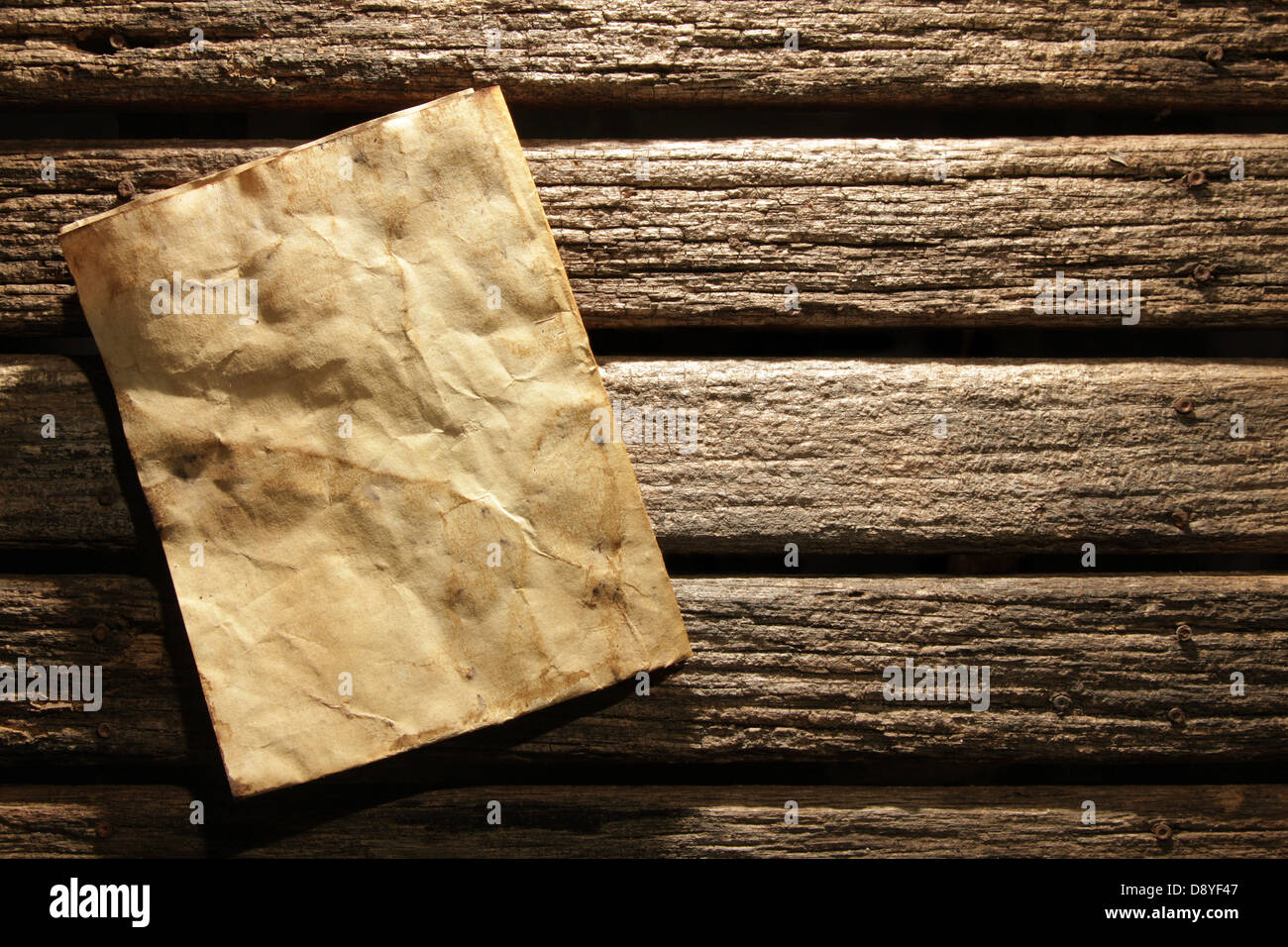 Old paper on wooden wall Stock Photo