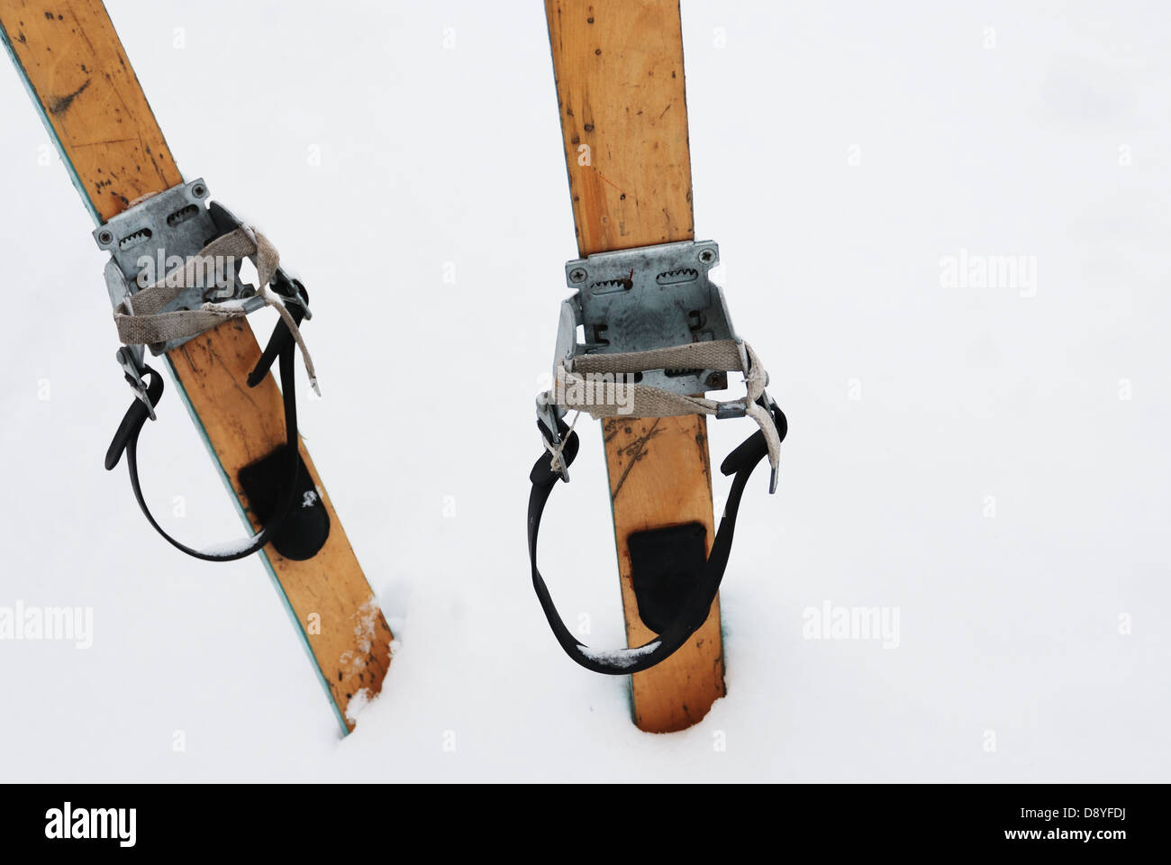 old wooden skis in the snow, horizontal Stock Photo