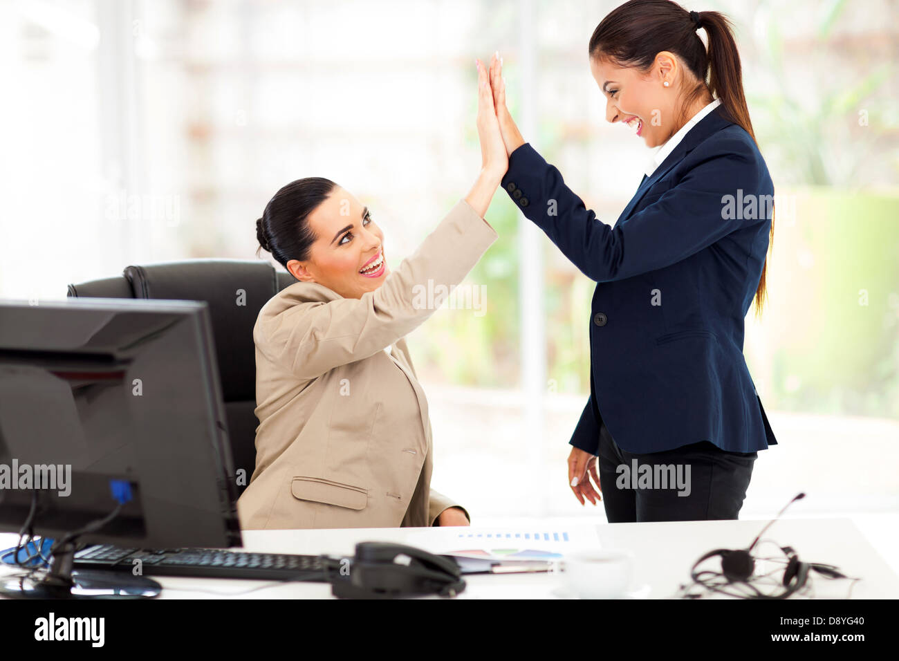happy young business women doing high five in office Stock Photo - Alamy